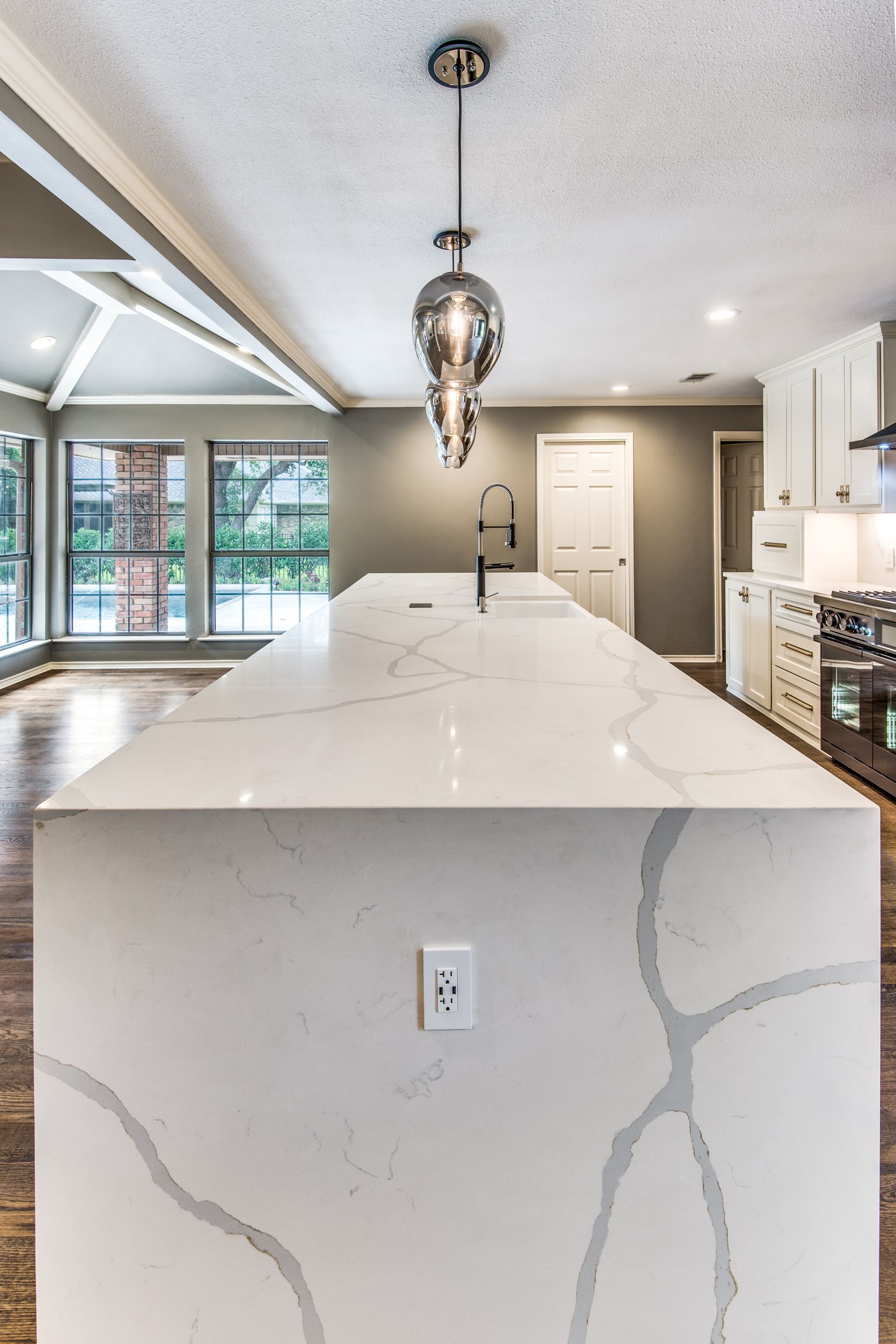 A kitchen with a large island and a sink.