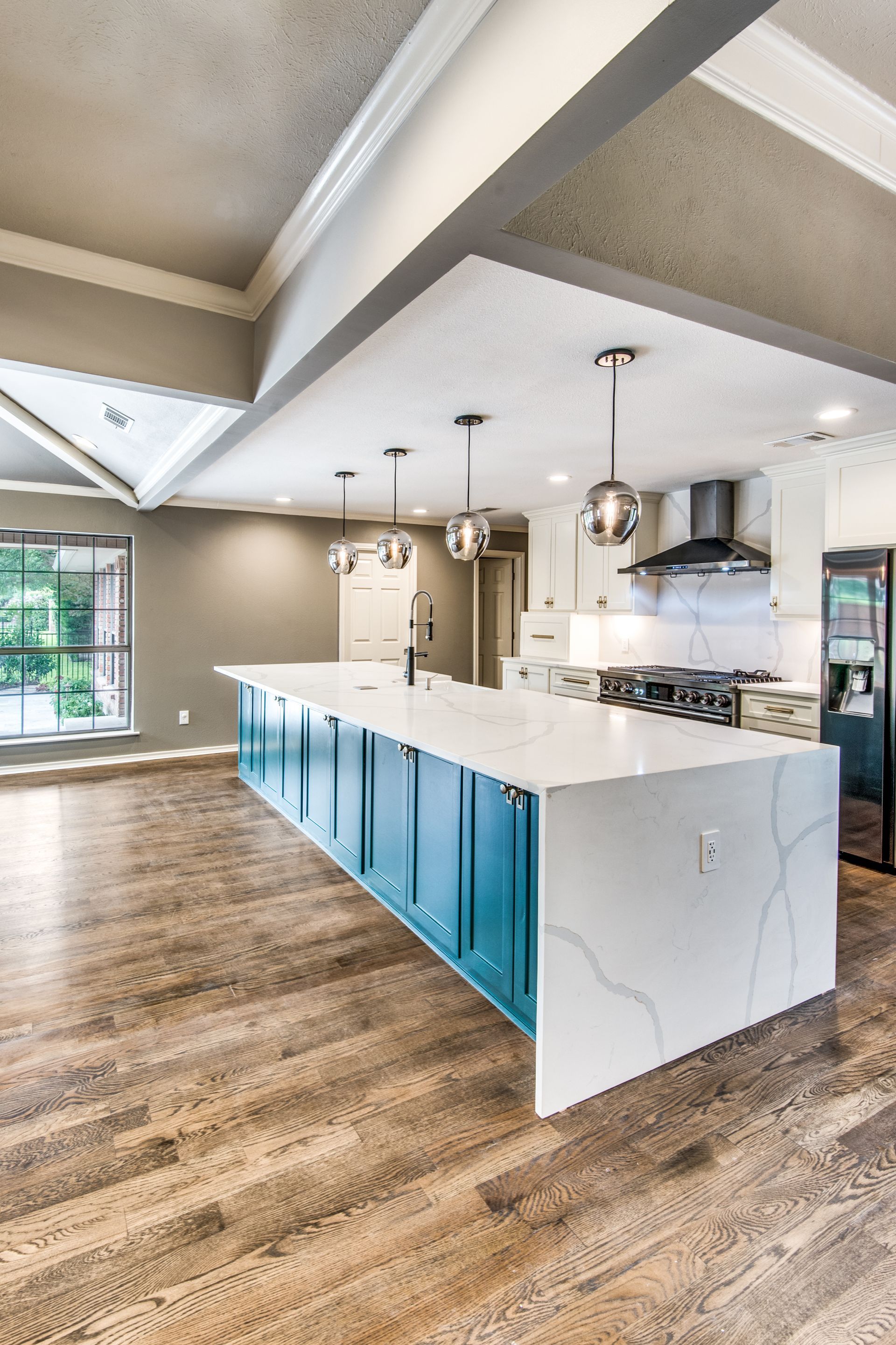 There is a large island in the middle of the kitchen.