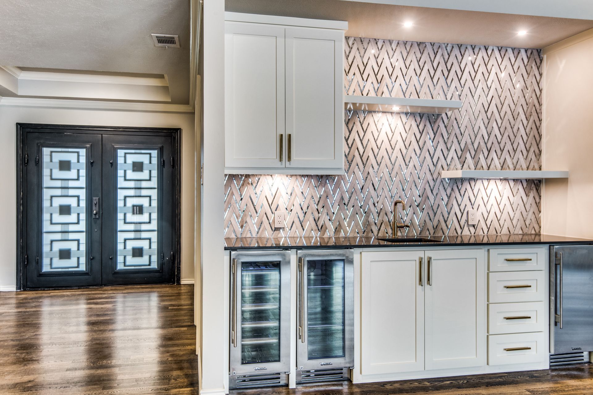 A kitchen with white cabinets and stainless steel appliances