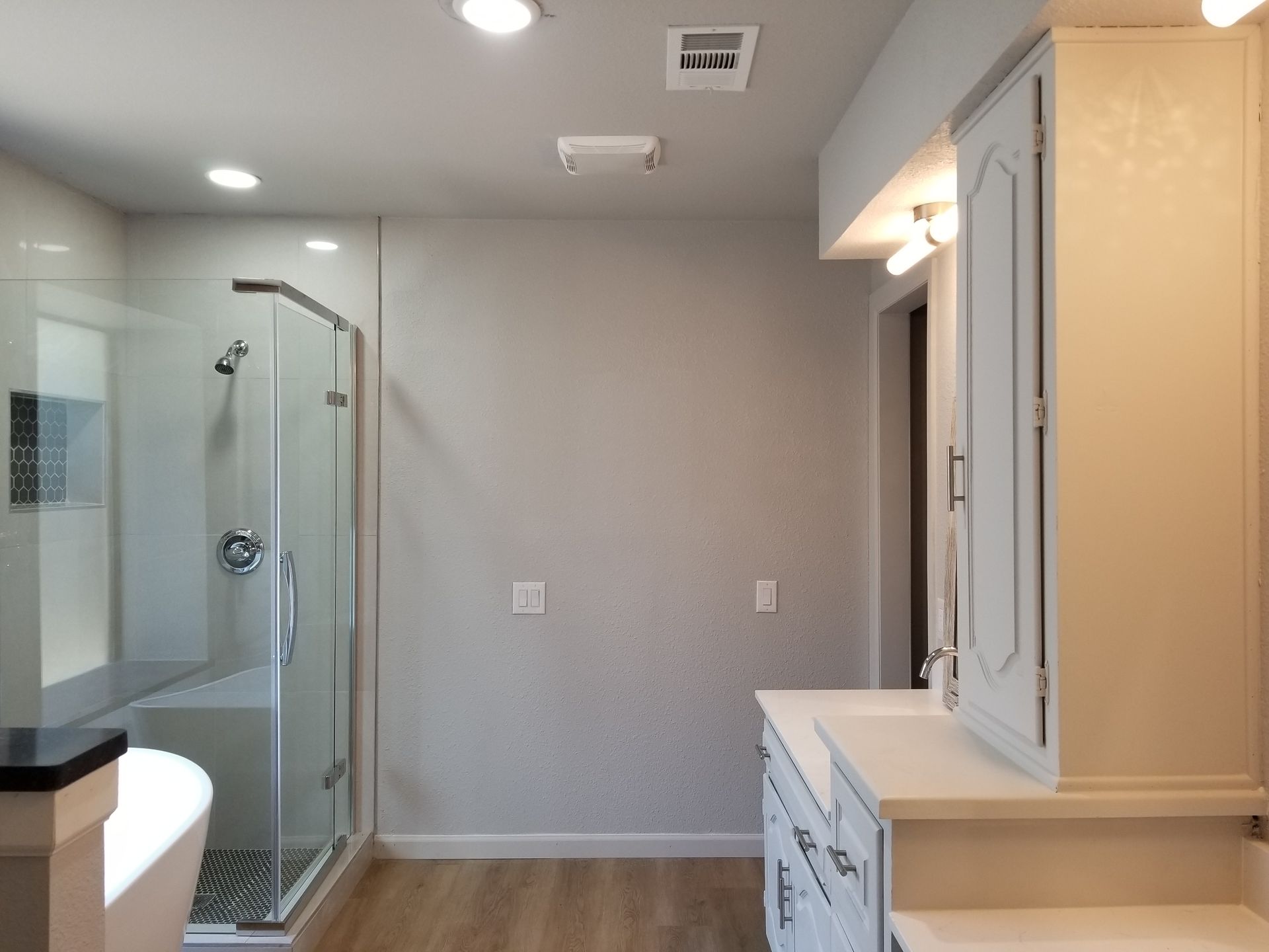 A bathroom remodel with a walk in shower and a bathtub