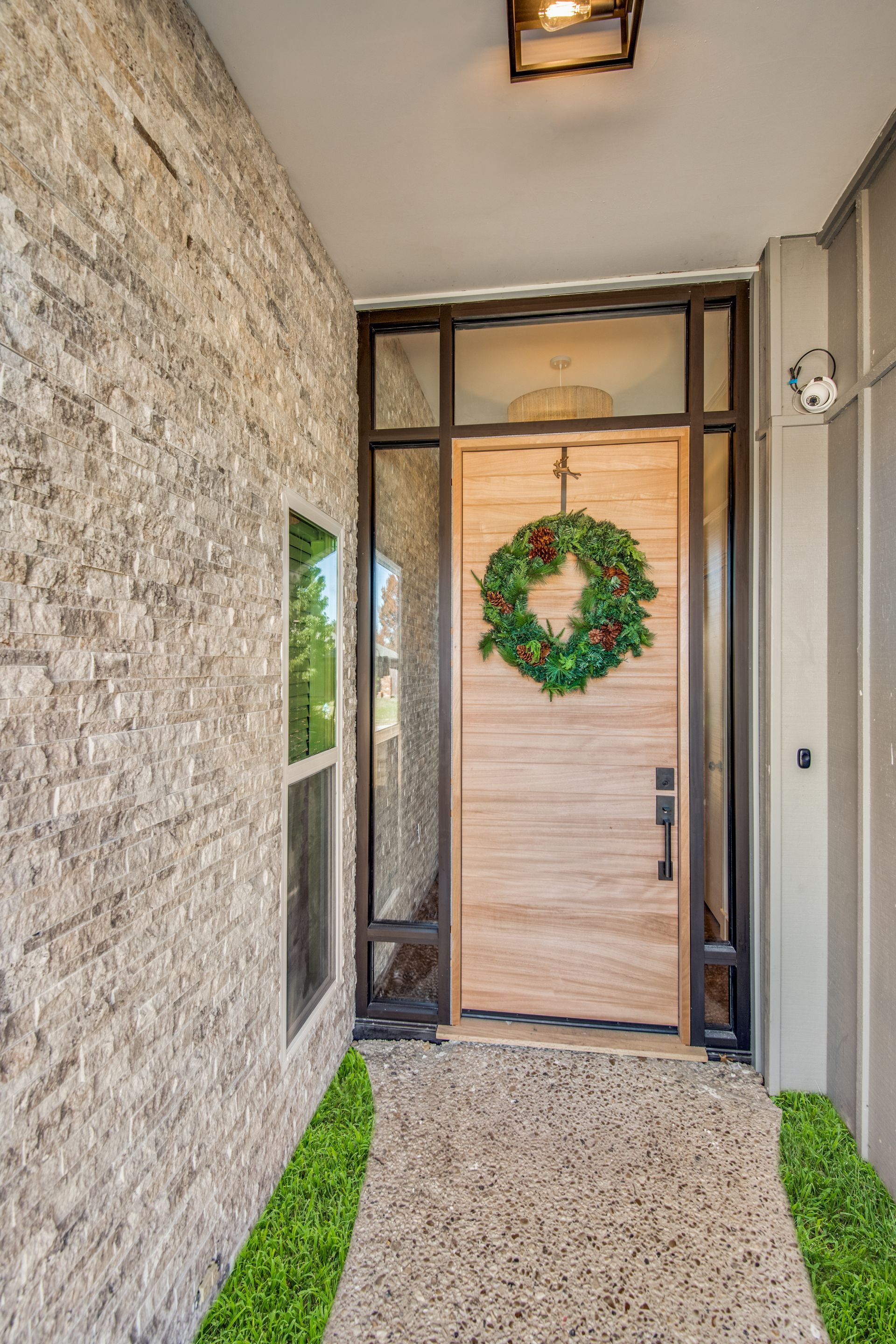 A wooden door with a christmas wreath hanging on it.