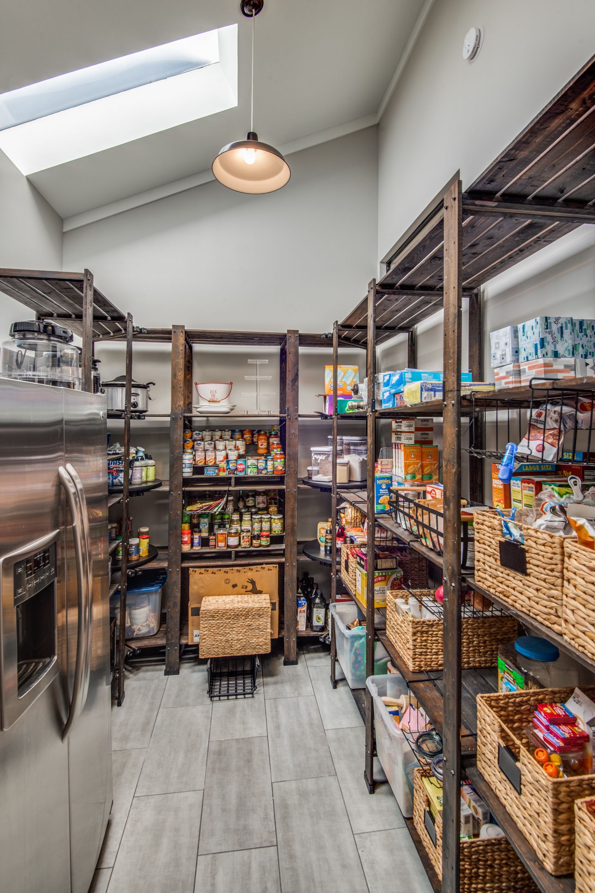 A plano home remodel pantry filled with lots of food and a refrigerator.