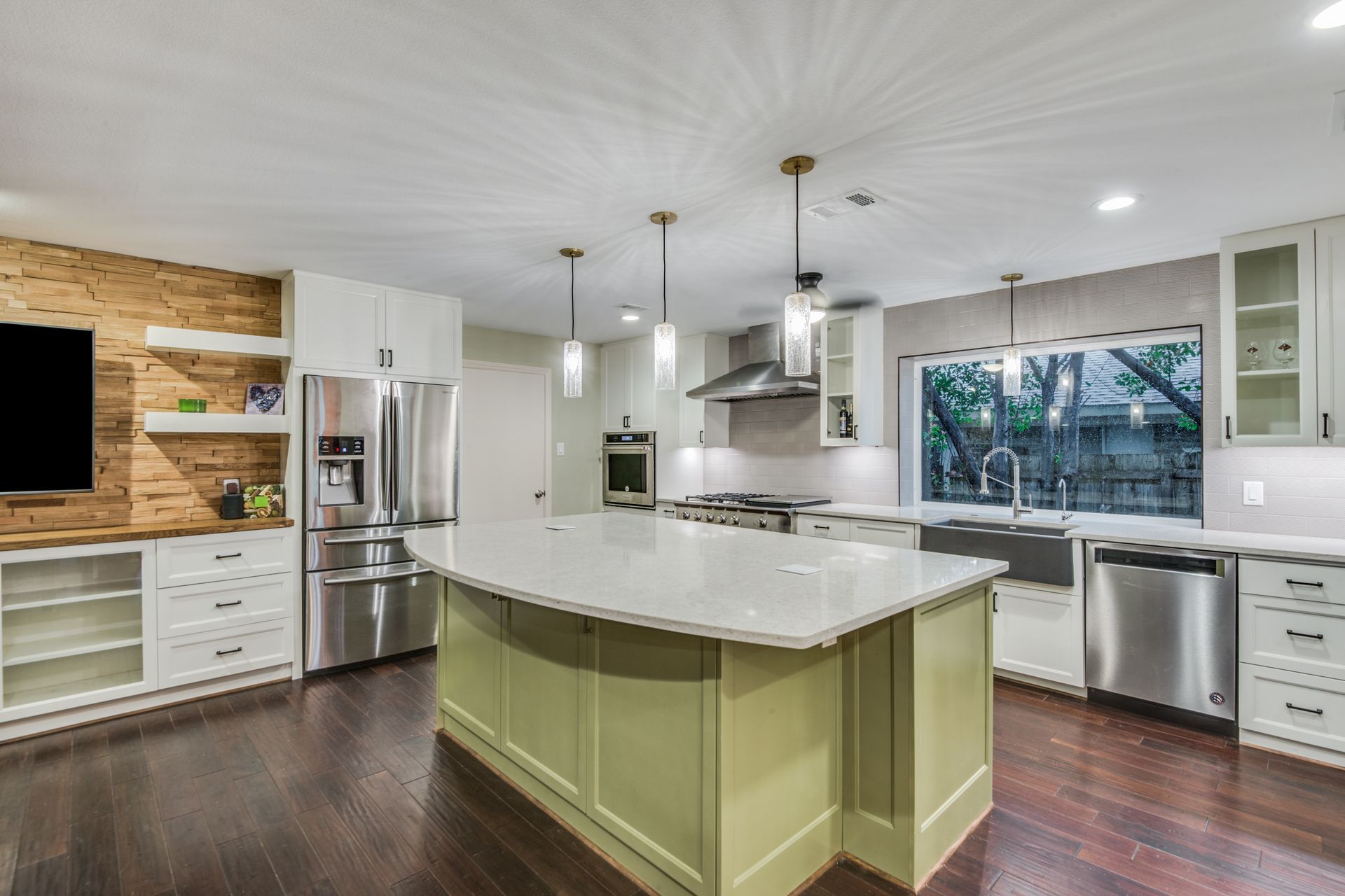 A kitchen with stainless steel appliances and a large island.