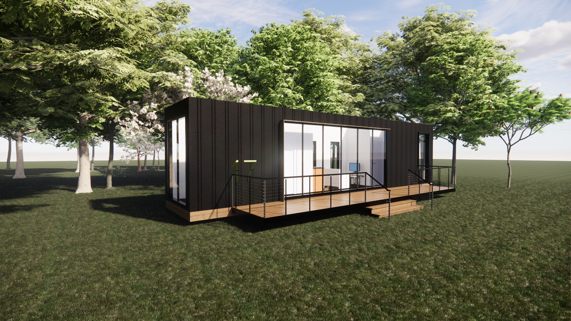 A small house is sitting in the middle of a grassy field surrounded by trees.