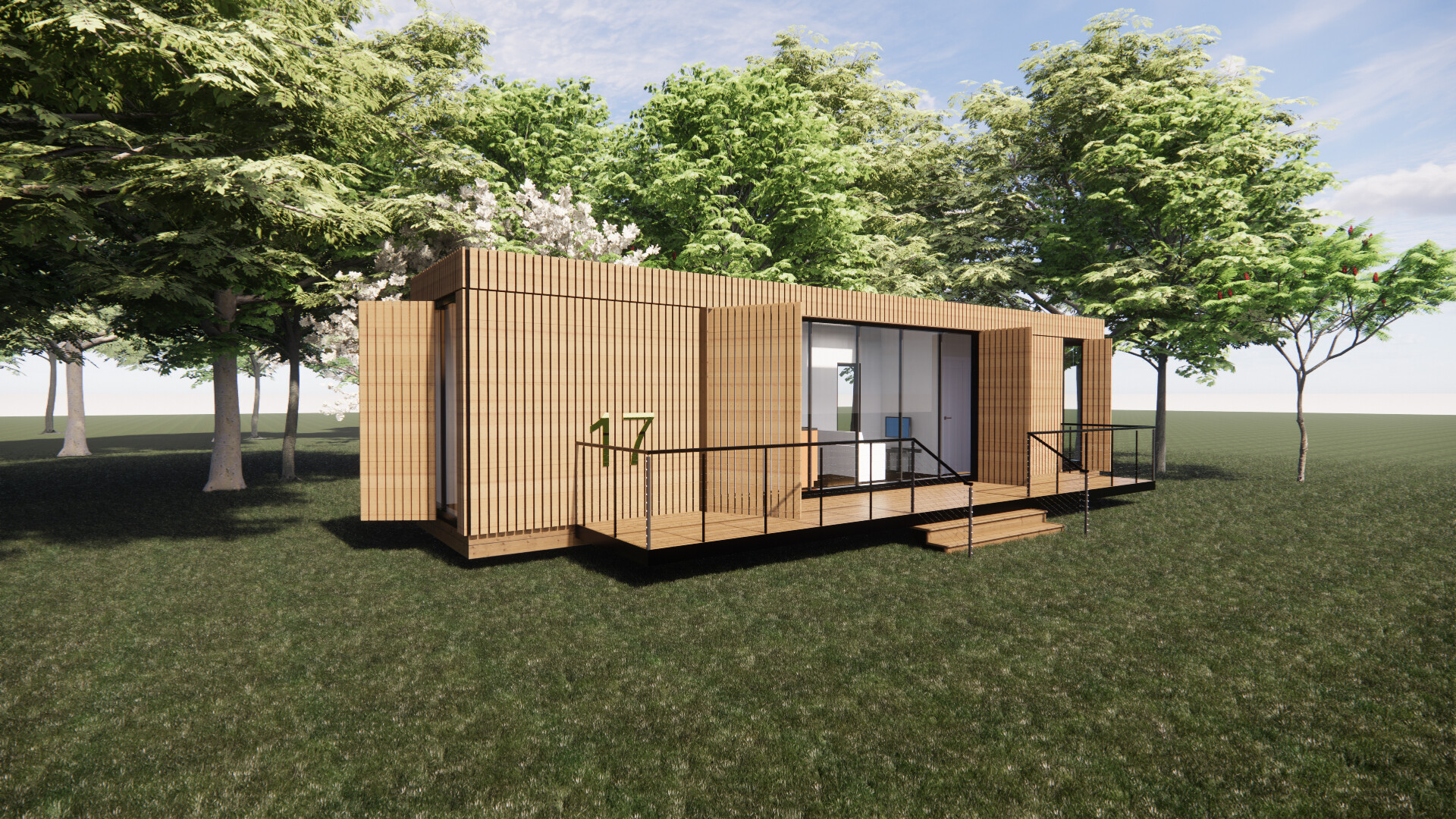 A shipping container  house is sitting on top of a lush green field surrounded by trees.