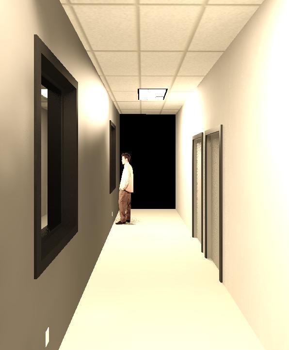 A man is standing in a hallway looking out a window