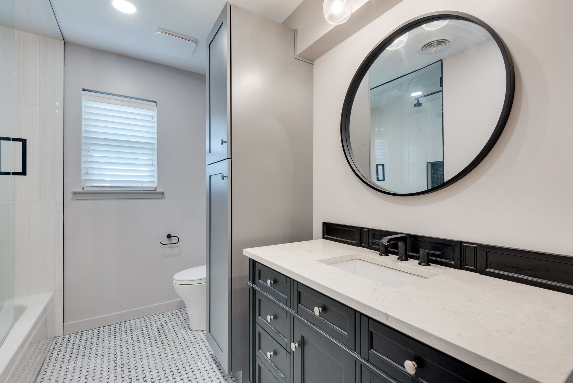 A bathroom with a sink , toilet , and mirror.