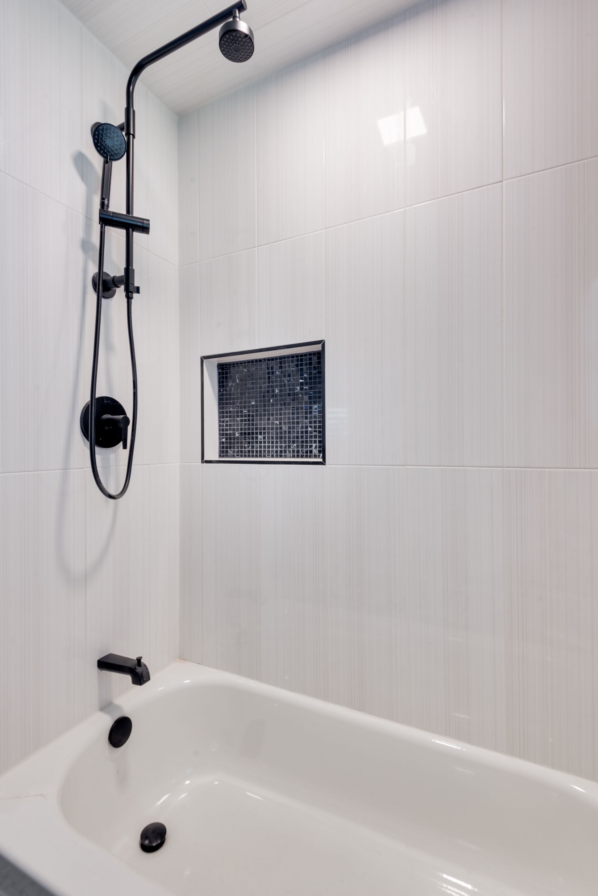 A bathroom with a bathtub and a shower.