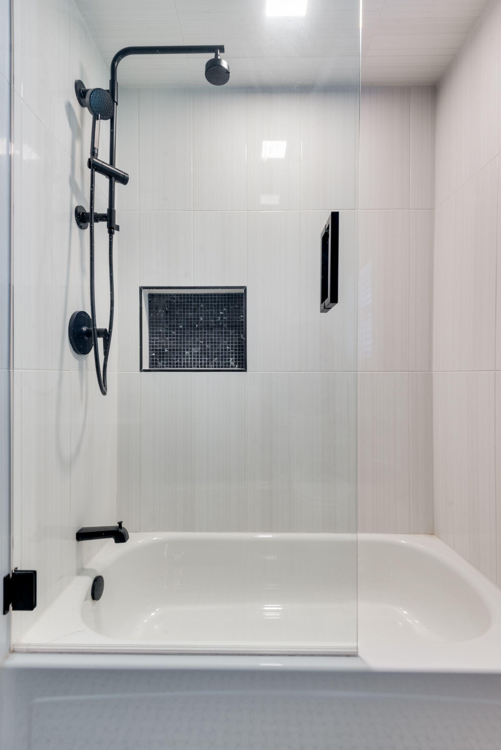 A bathroom with a bathtub and a shower.