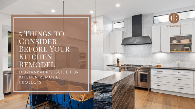 Kitchen remodel: modern design with white cabinets, black island, stainless steel appliances.