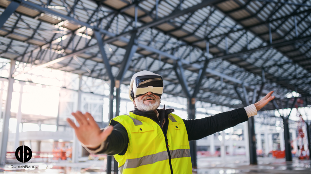 A construction man wearing a virtual reality headset is standing in a building with his arms outstretched.