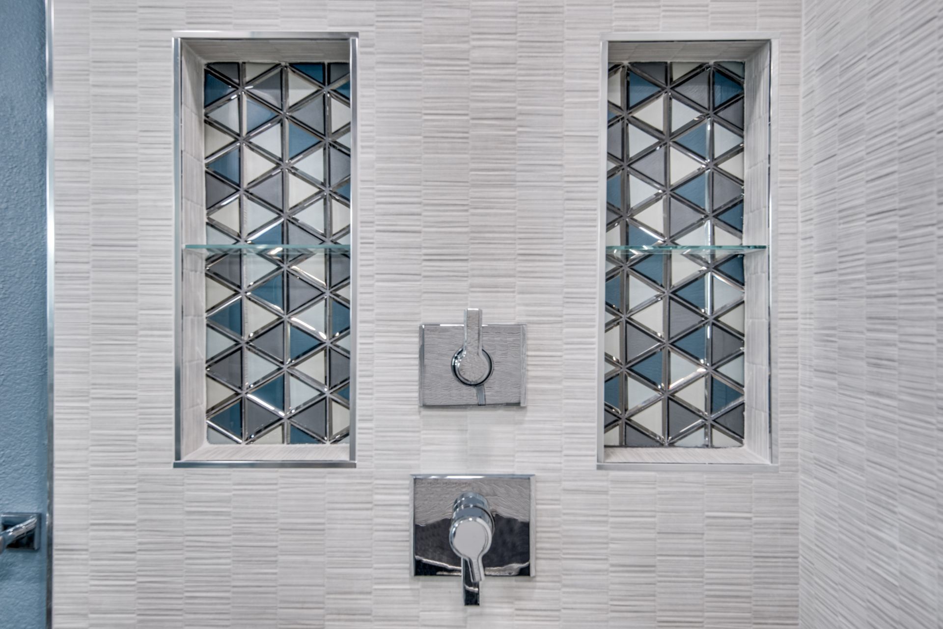 A bathroom remodel with two windows and a shower head.