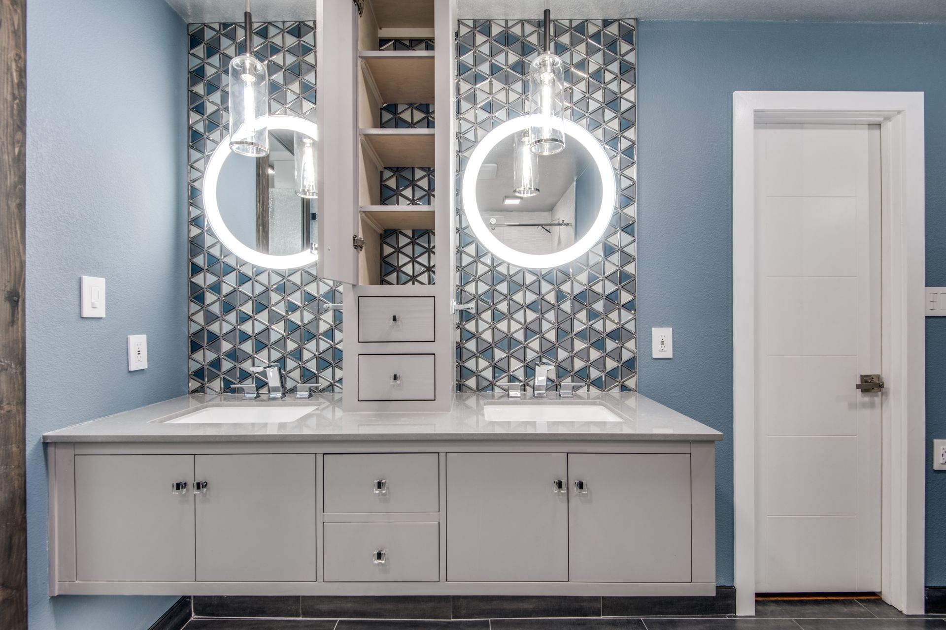 A bathroom remodel with two sinks and two mirrors.