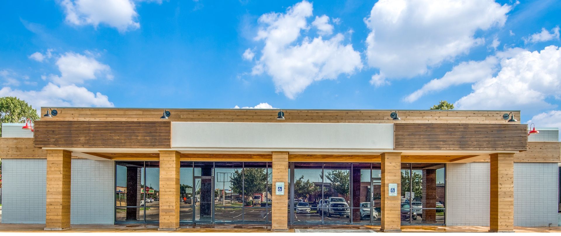 A large building with a blue sky and clouds in the background.