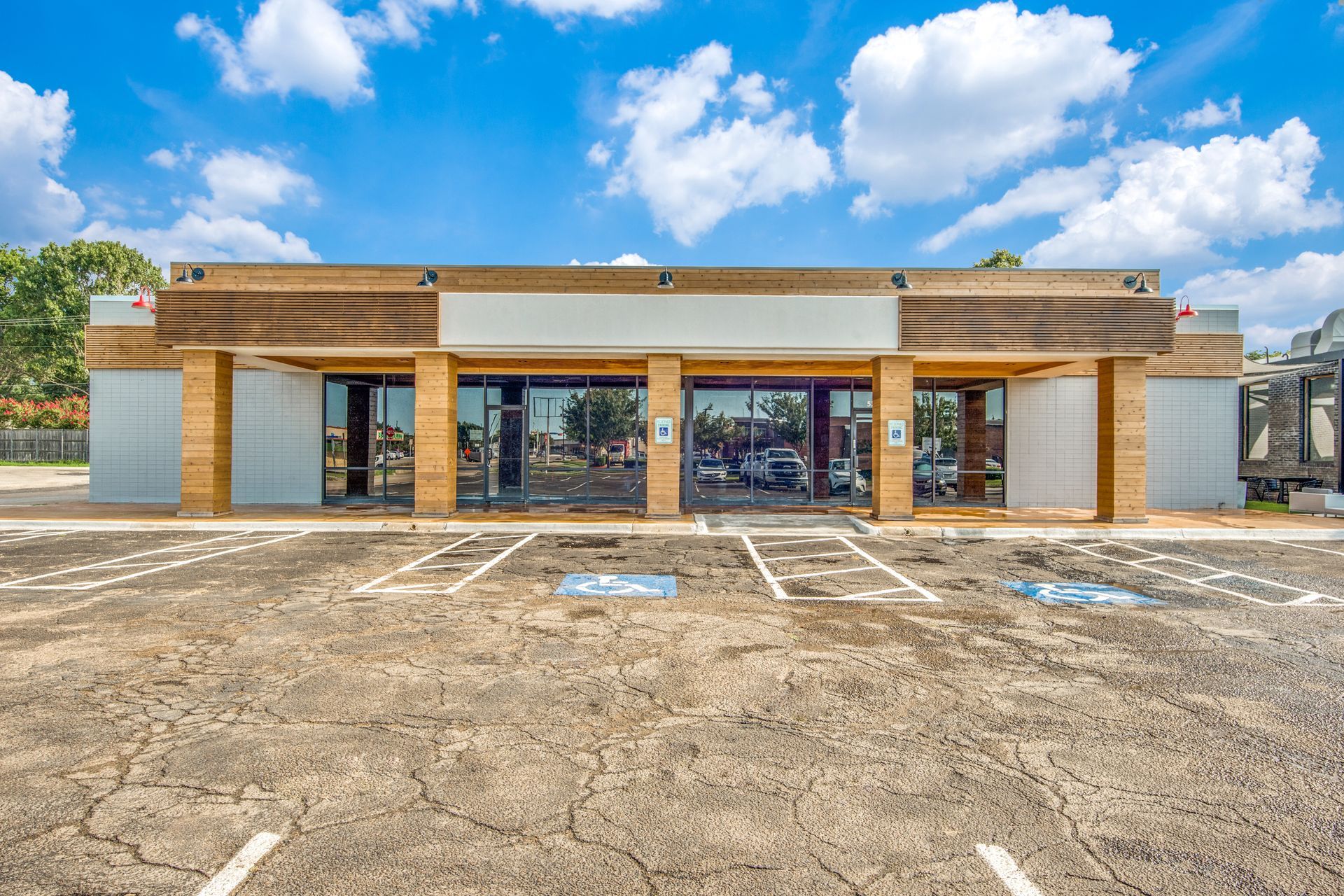 A large building with a parking lot in front of it