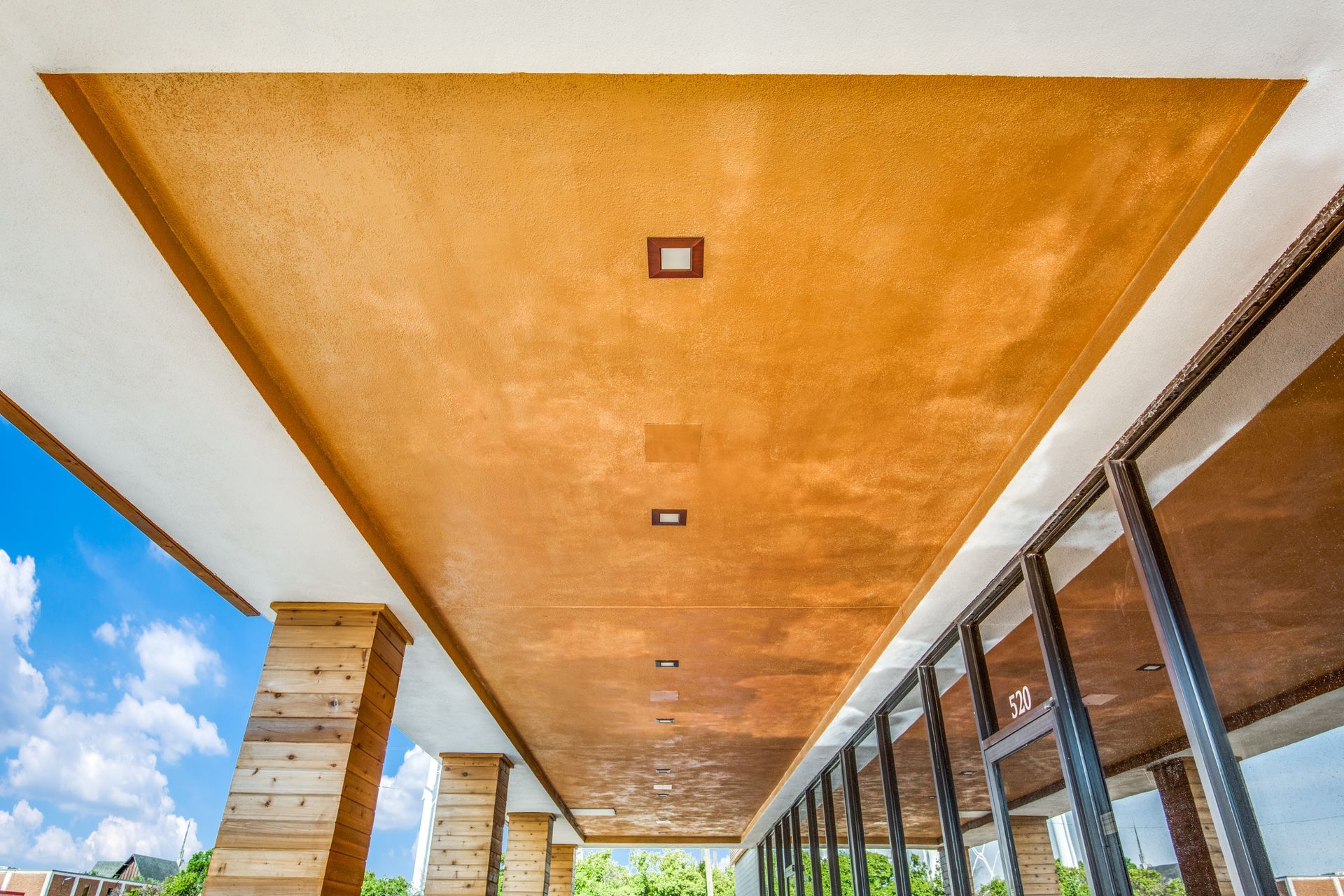 A building with a wooden ceiling and a lot of windows.