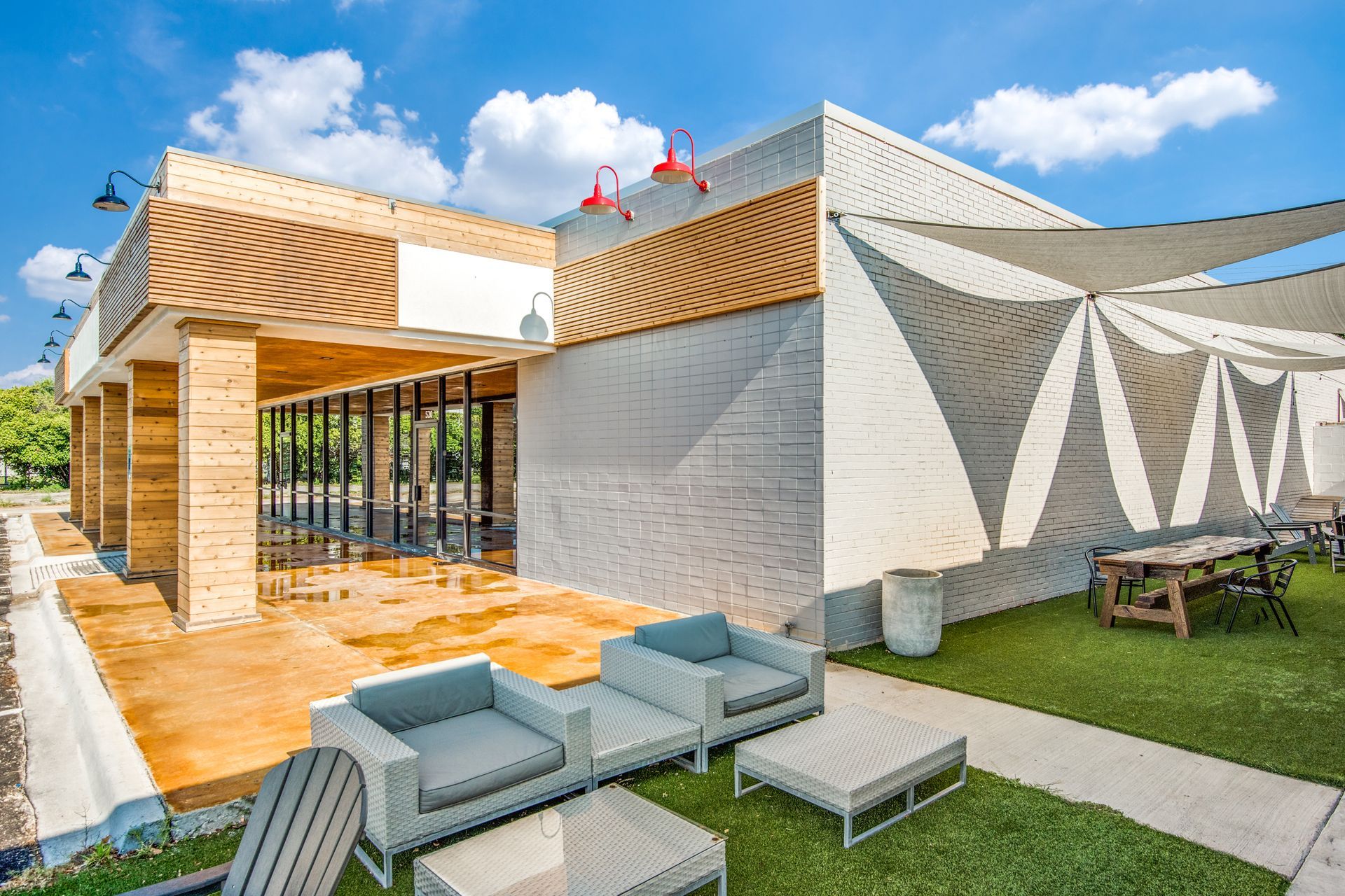 A large building with a lot of furniture in front of it.