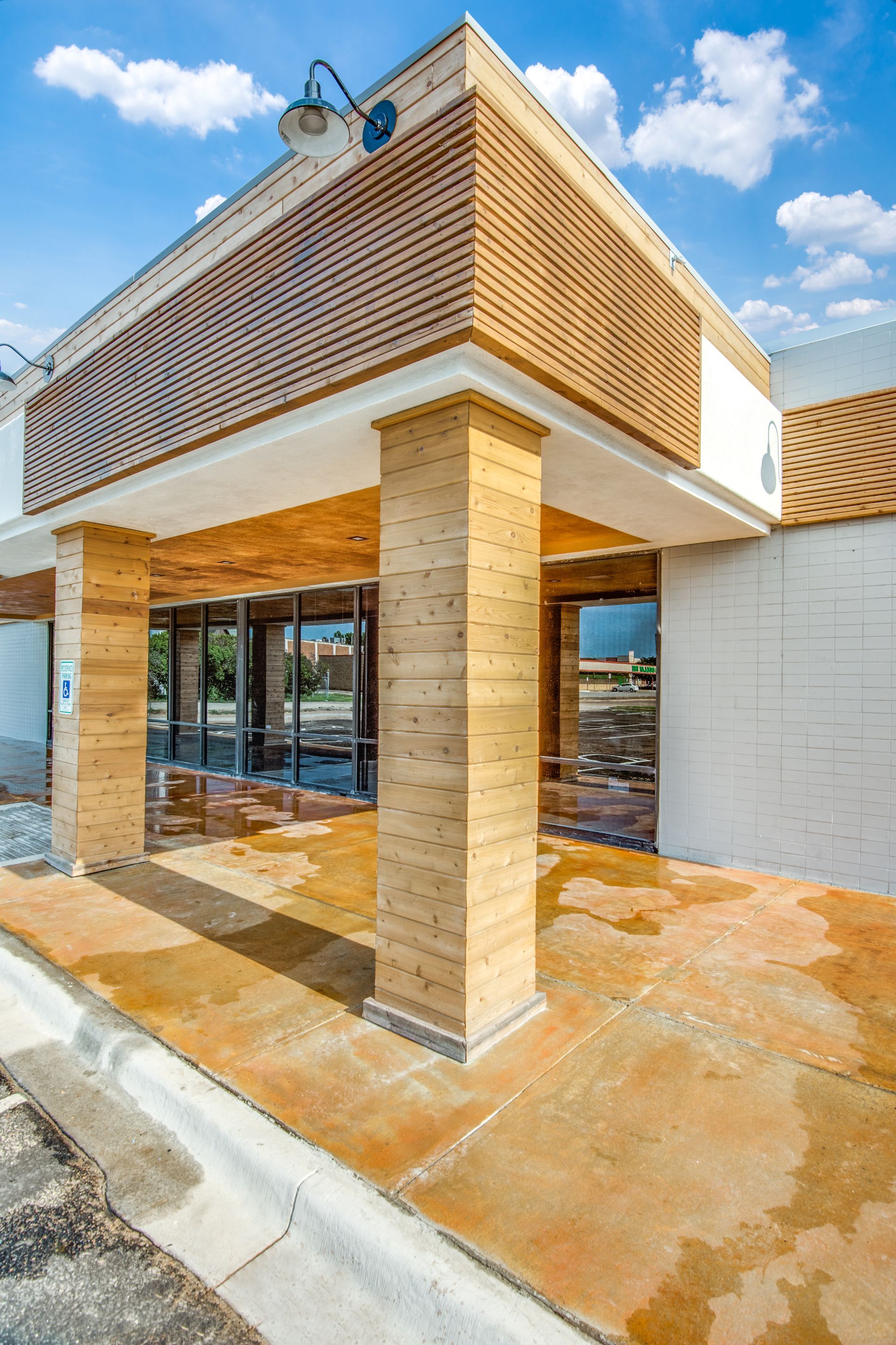 A large building with a lot of windows and a brick entrance.
