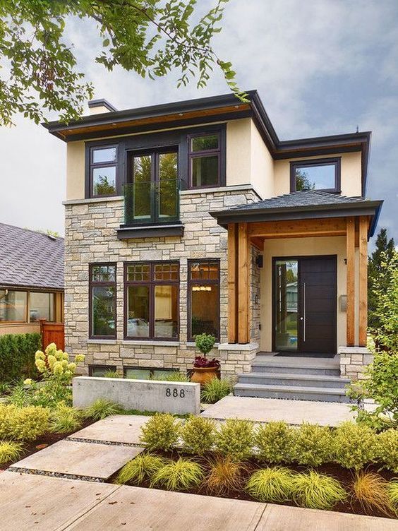 A house with a lot of windows and a black door