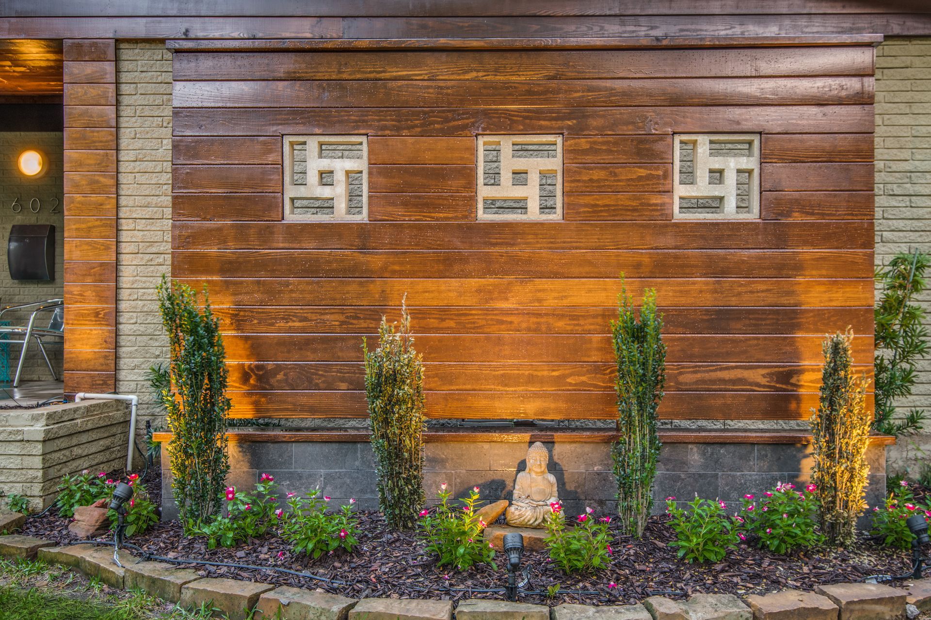 A wooden wall with a statue in front of it