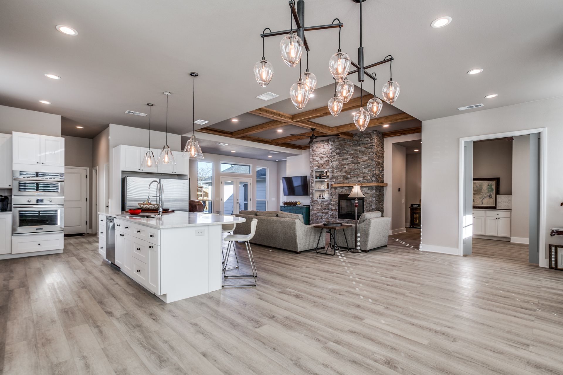 A large open floor plan with a kitchen , living room , and fireplace.