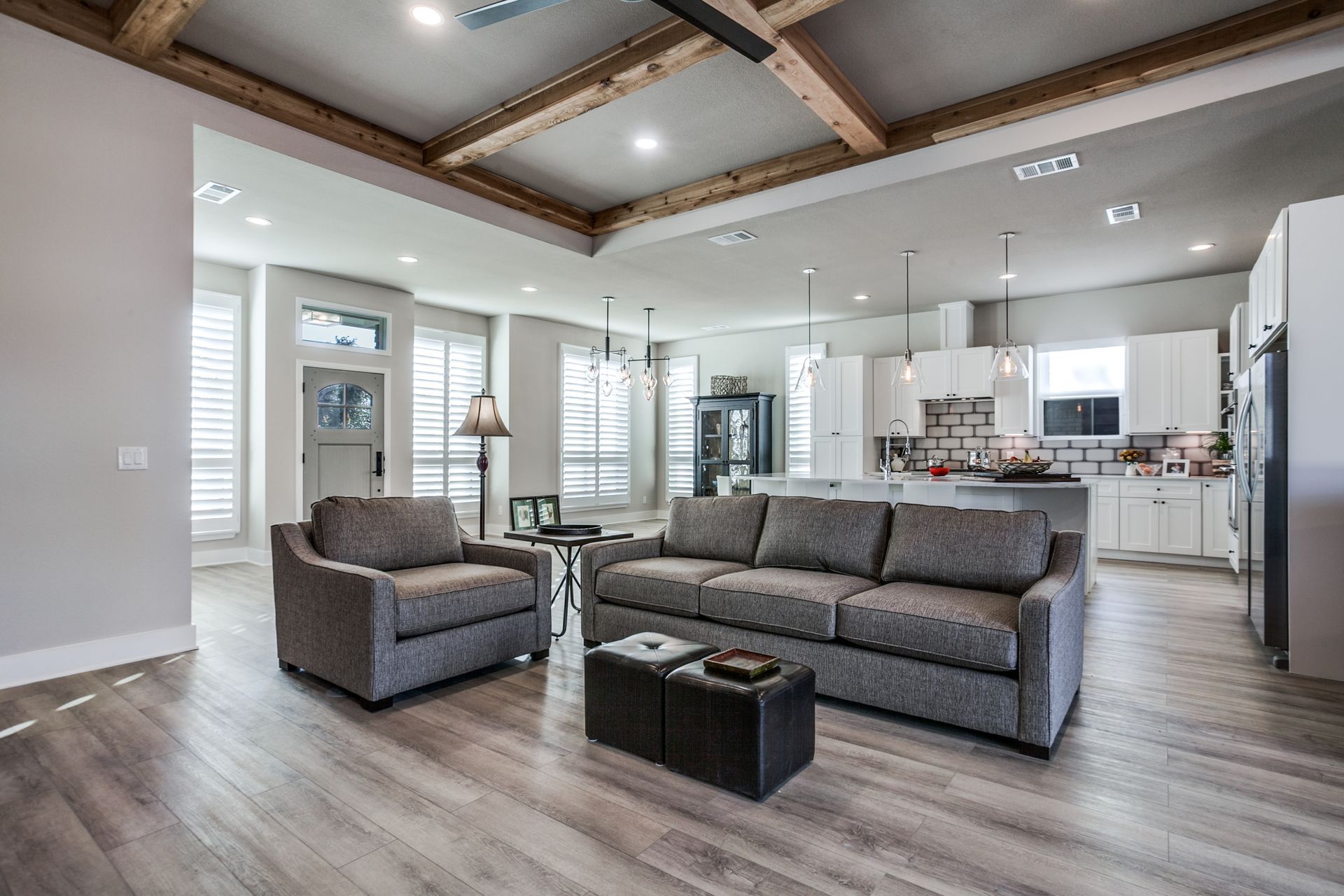 A living room with a couch , two chairs , and a coffee table.