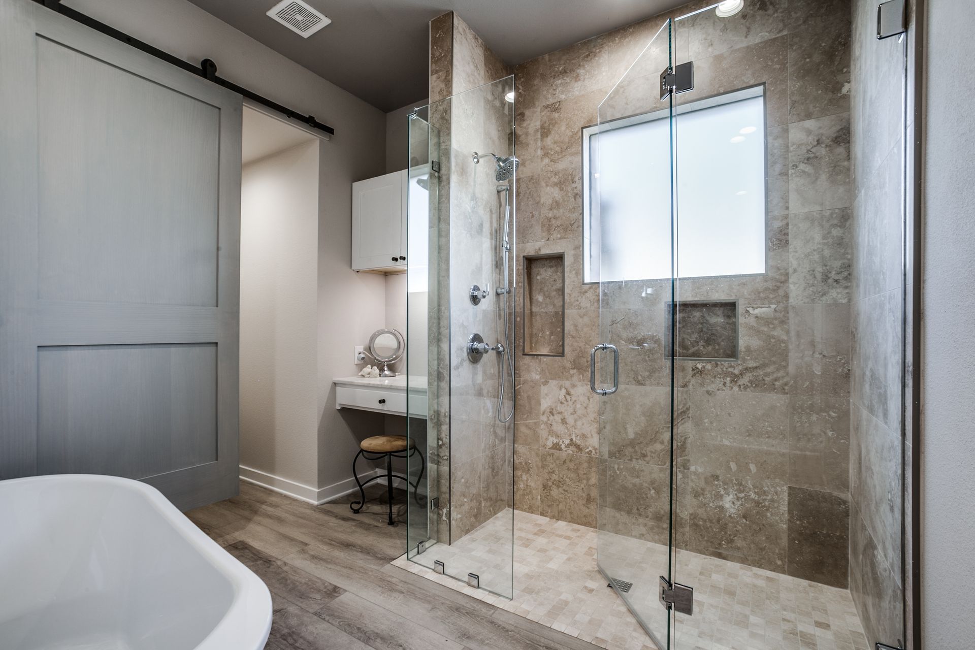 A bathroom with a walk in shower and a bathtub.