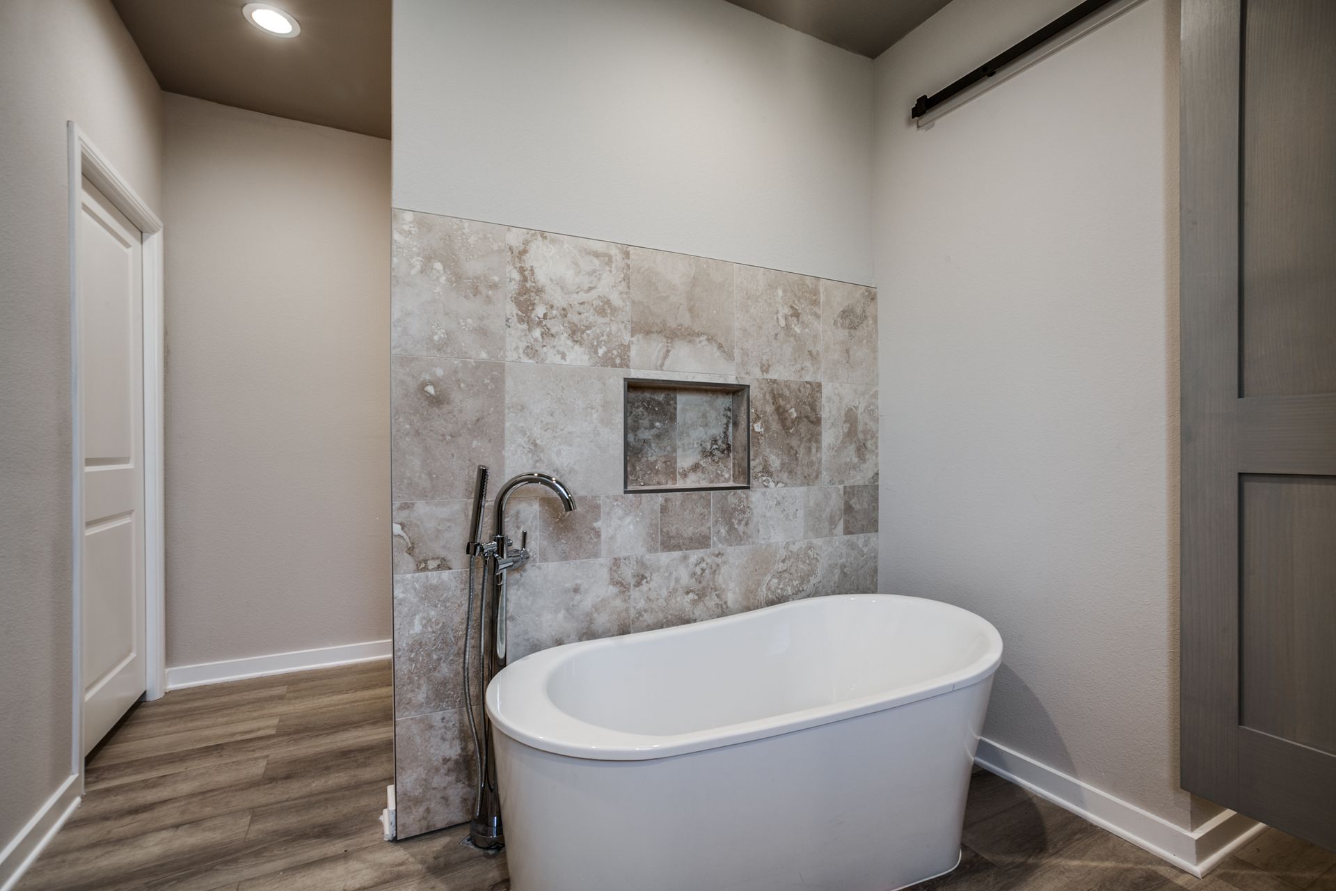 There is a bathtub in the middle of the bathroom.