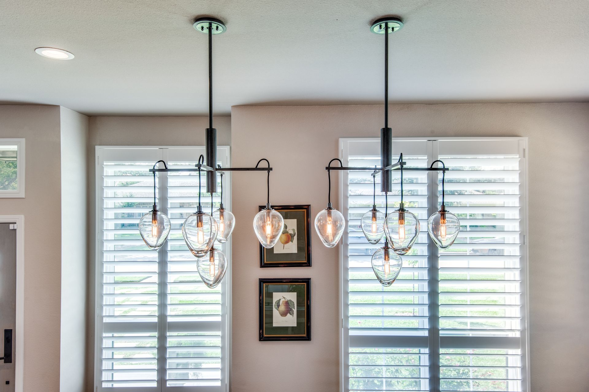 A dining room with a chandelier hanging from the ceiling