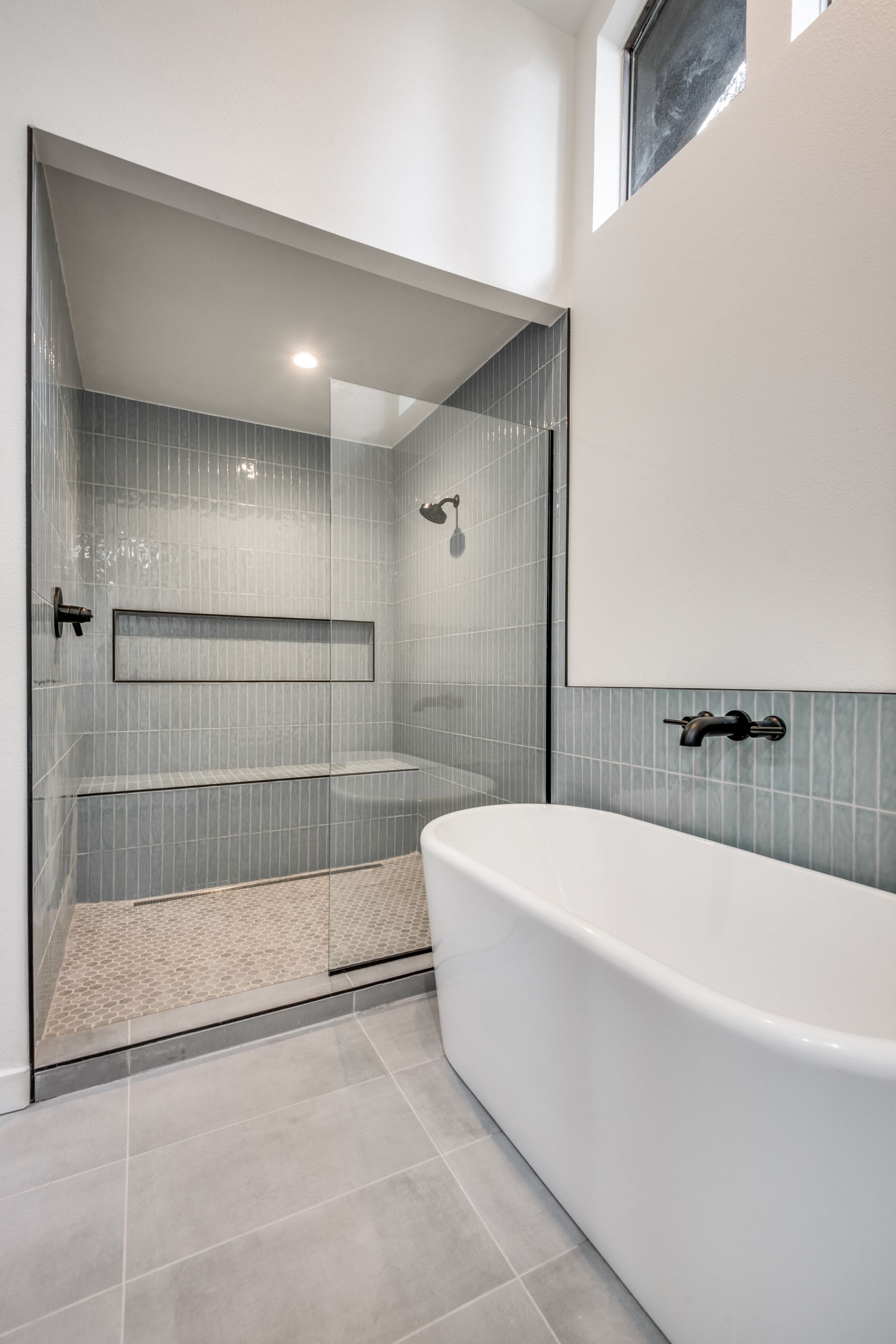 A bathroom with a bathtub and a walk in shower.