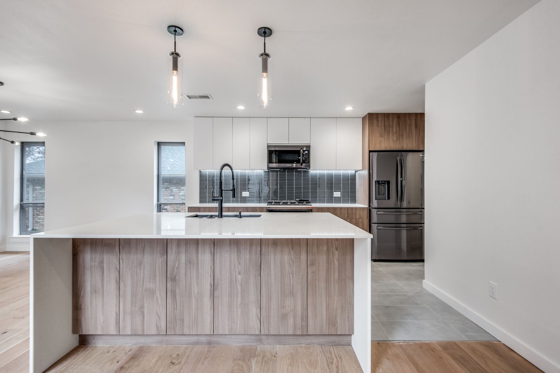 A kitchen with stainless steel appliances and wooden cabinets