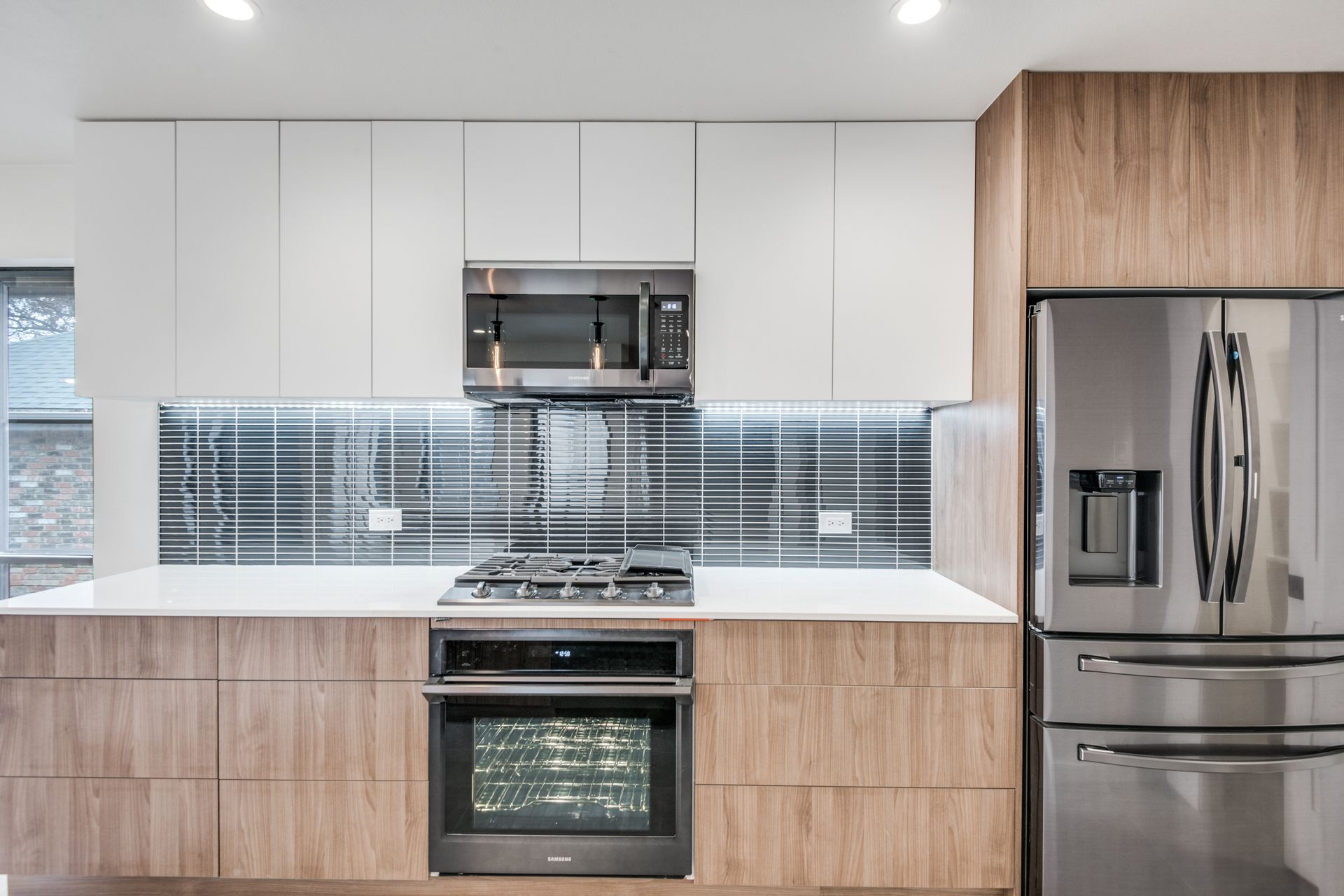 A kitchen with stainless steel appliances and wooden cabinets
