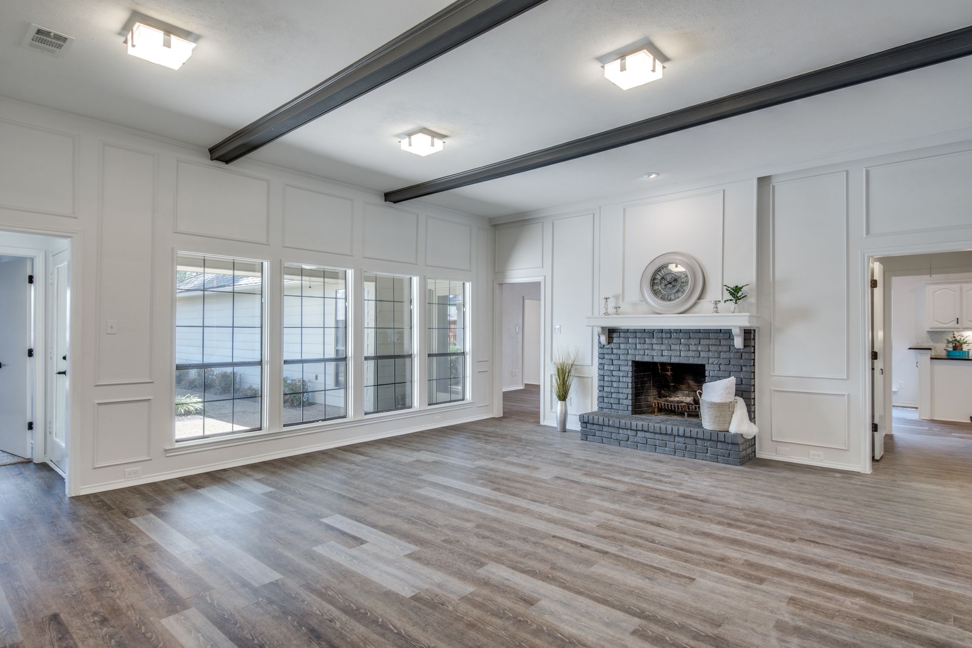 A living room with hardwood floors and a fireplace.