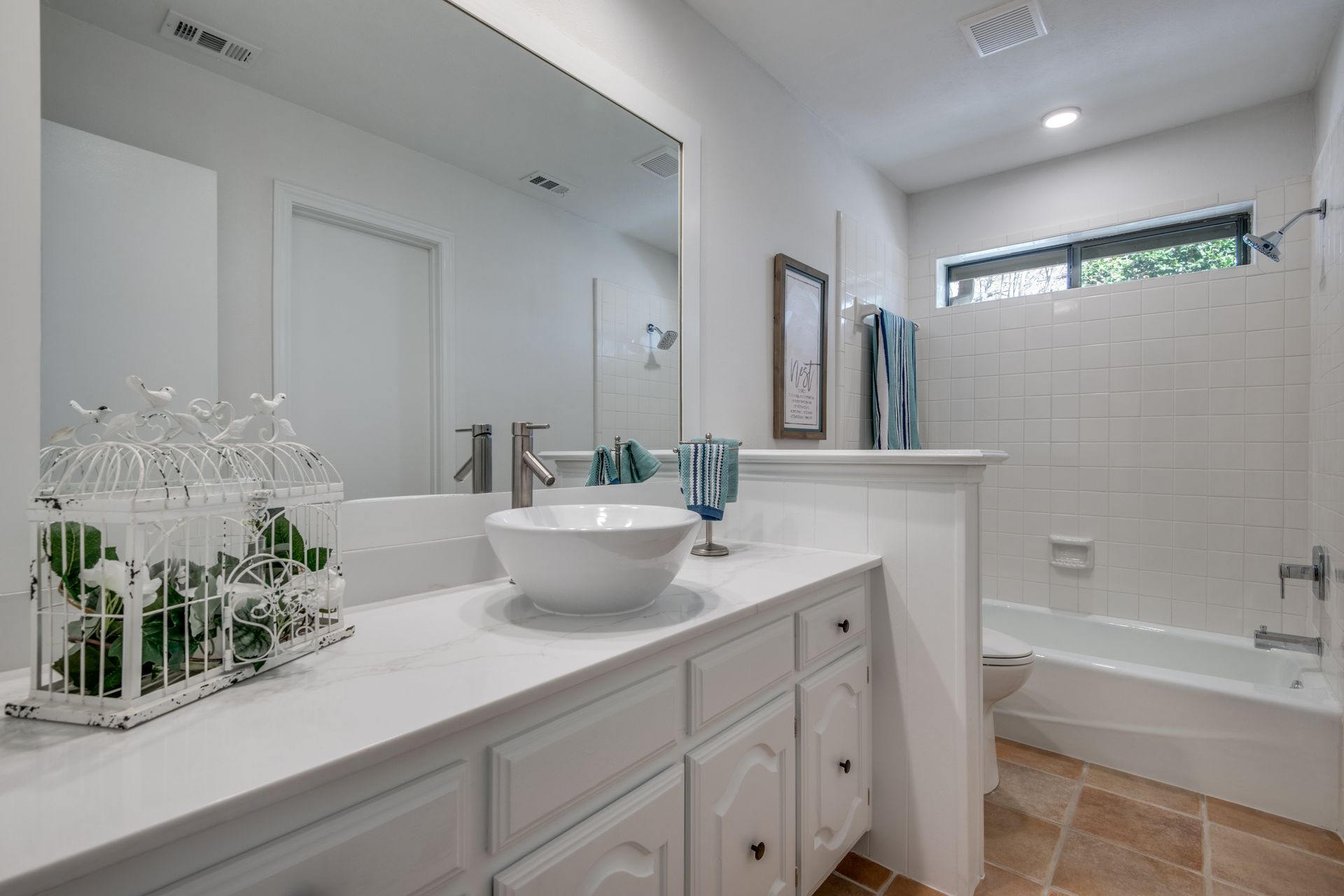 A bathroom remodel with a sink , mirror and tub.