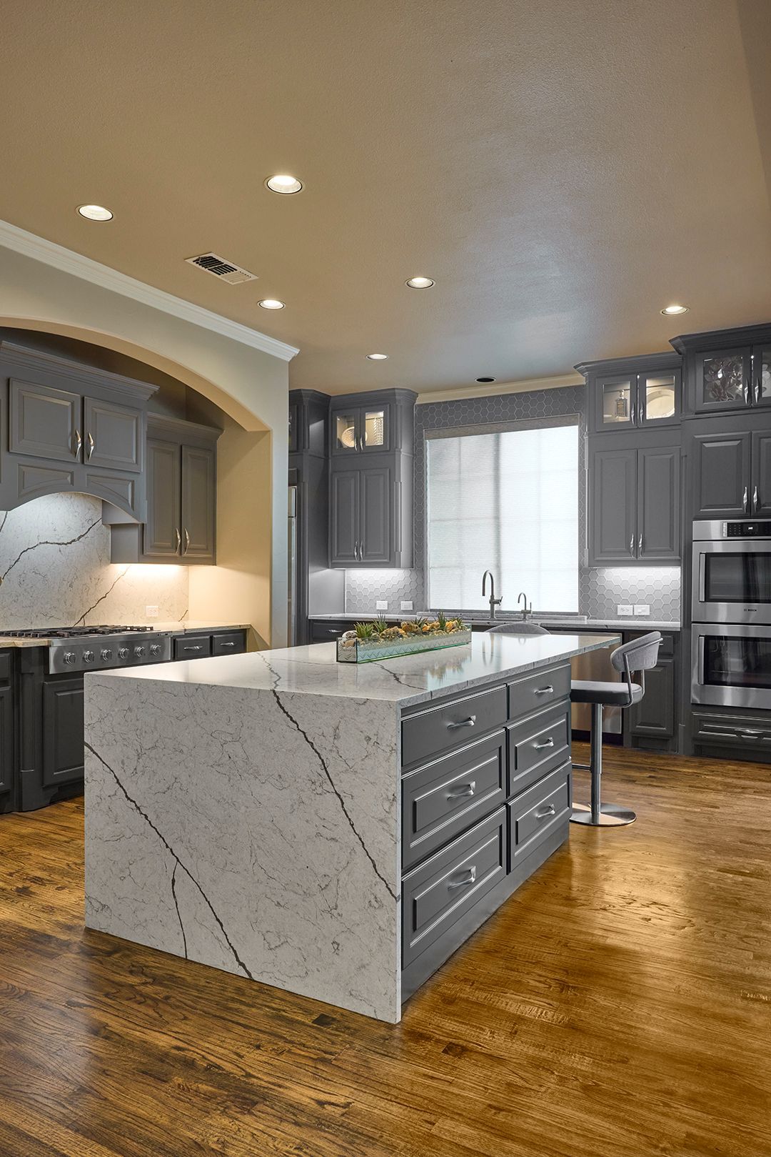 There is a large island in the middle of the kitchen.