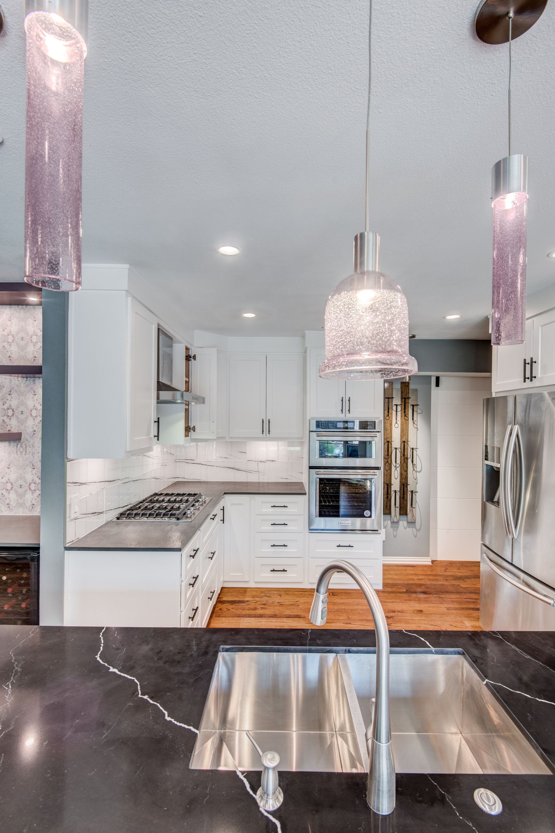 A kitchen with stainless steel appliances and a stainless steel sink.