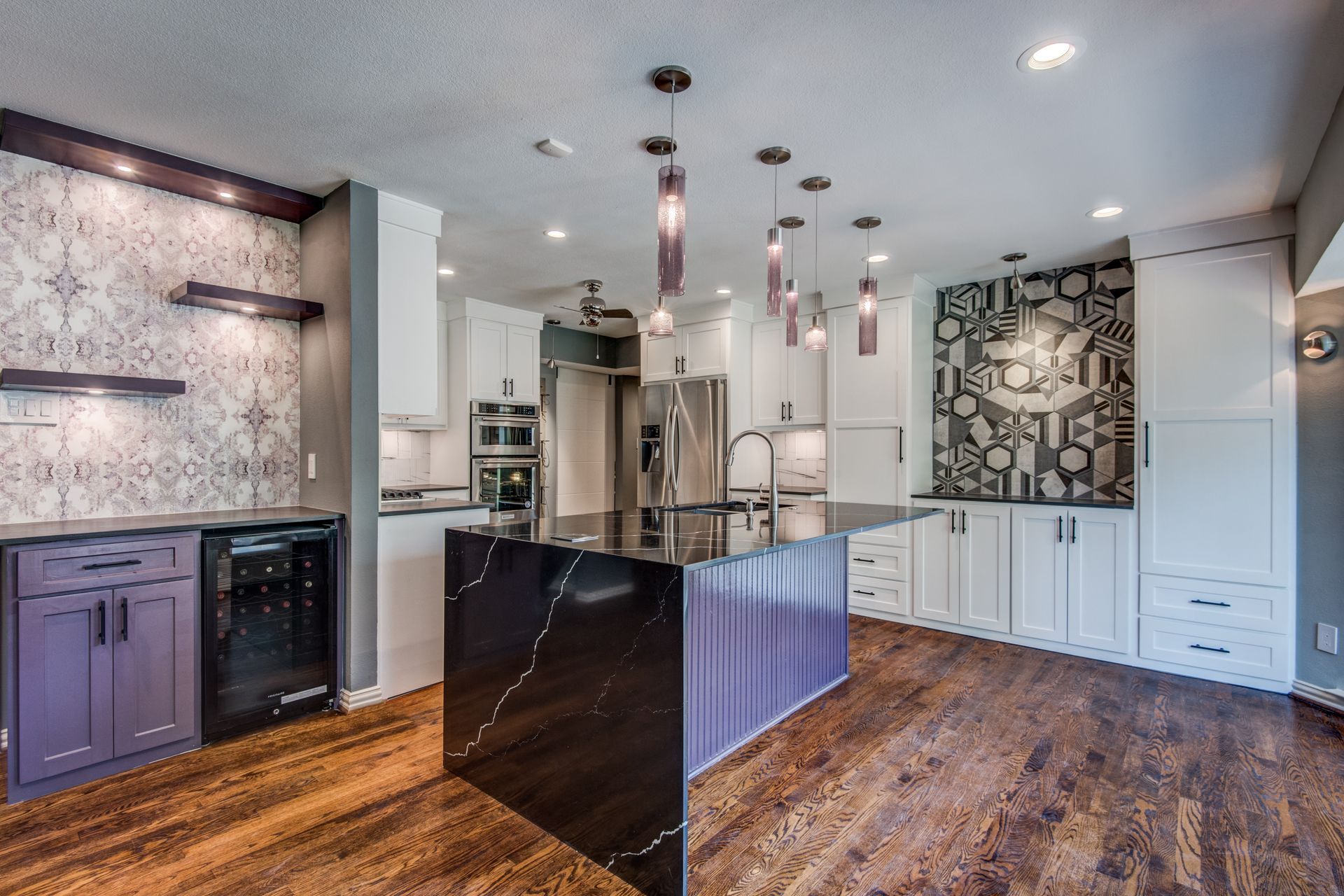 A Richardson remodel kitchen with purple cabinets and a black island