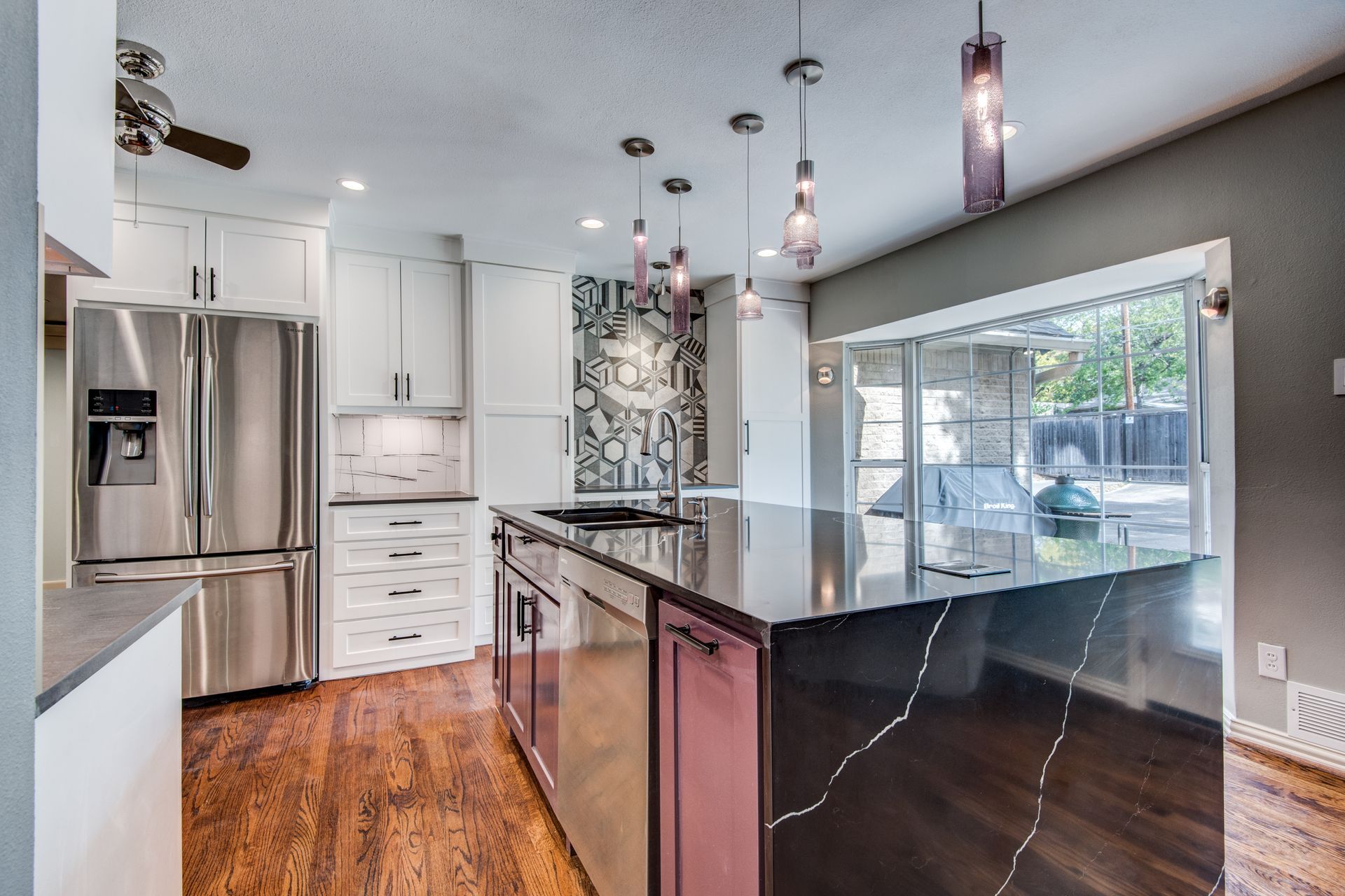 A kitchen with stainless steel appliances and a large island.