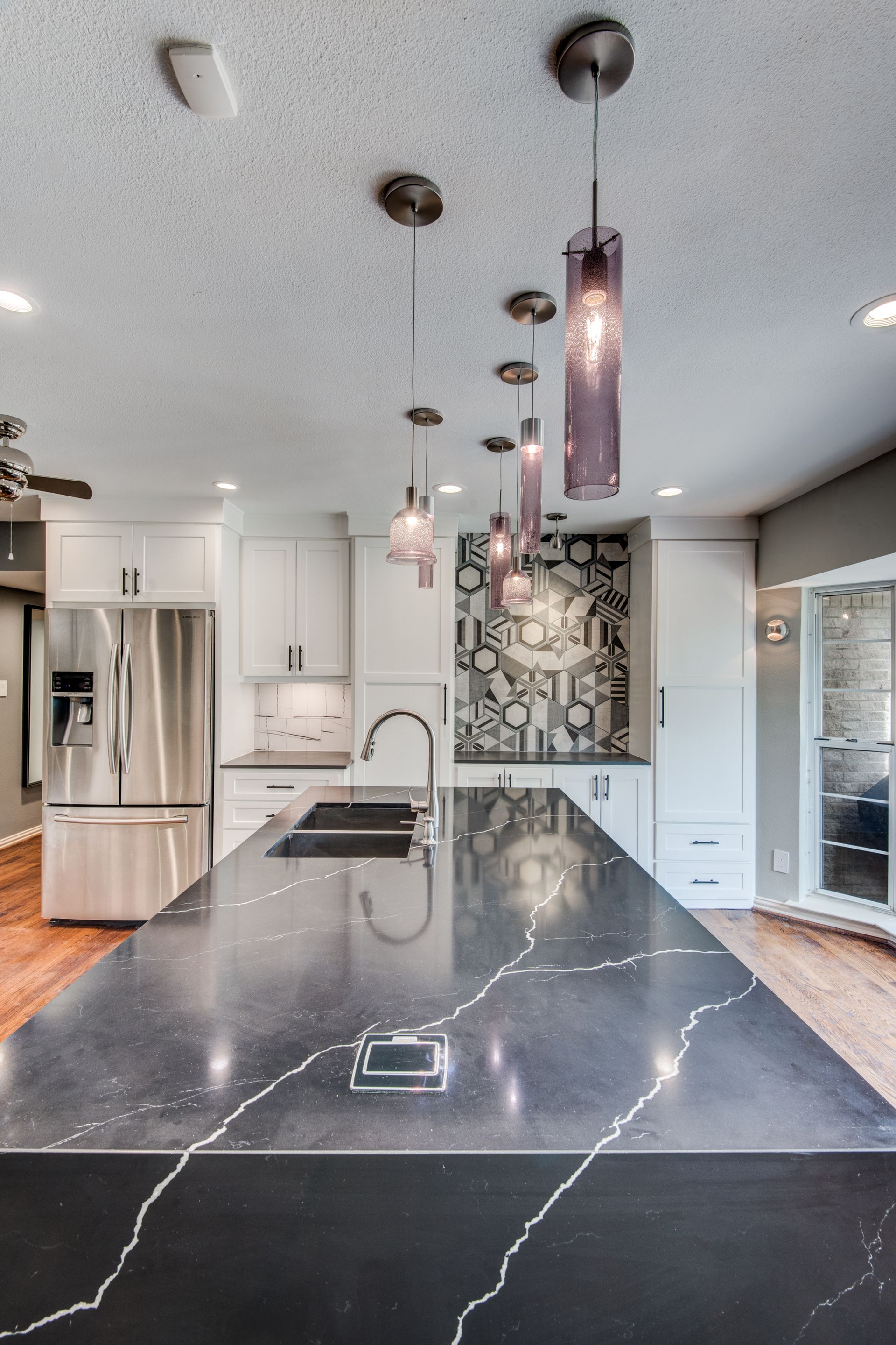 A kitchen with a large island and a sink.