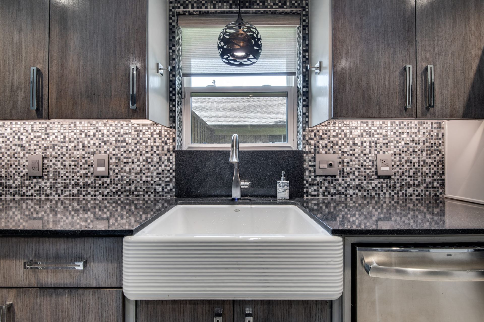 A kitchen with a sink and a window.