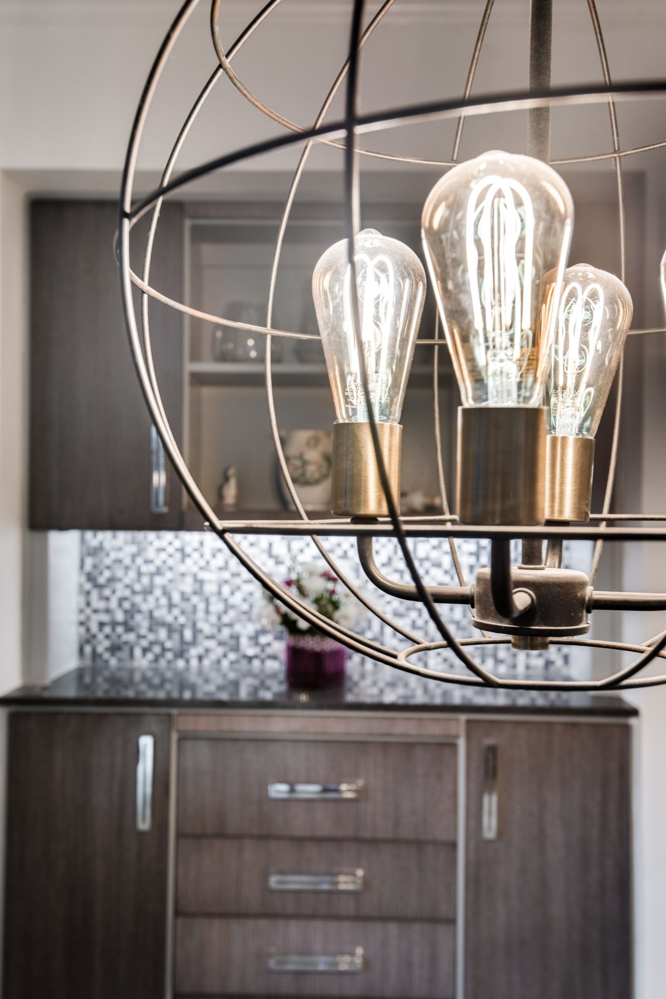 A chandelier is hanging from the ceiling in a kitchen.