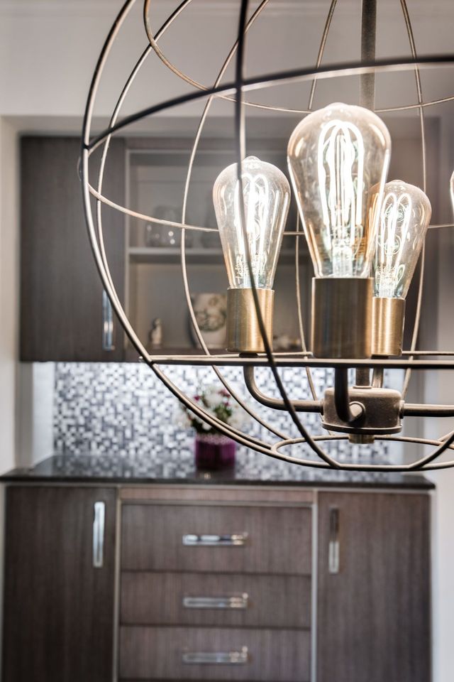 A chandelier is hanging from the ceiling in a kitchen.