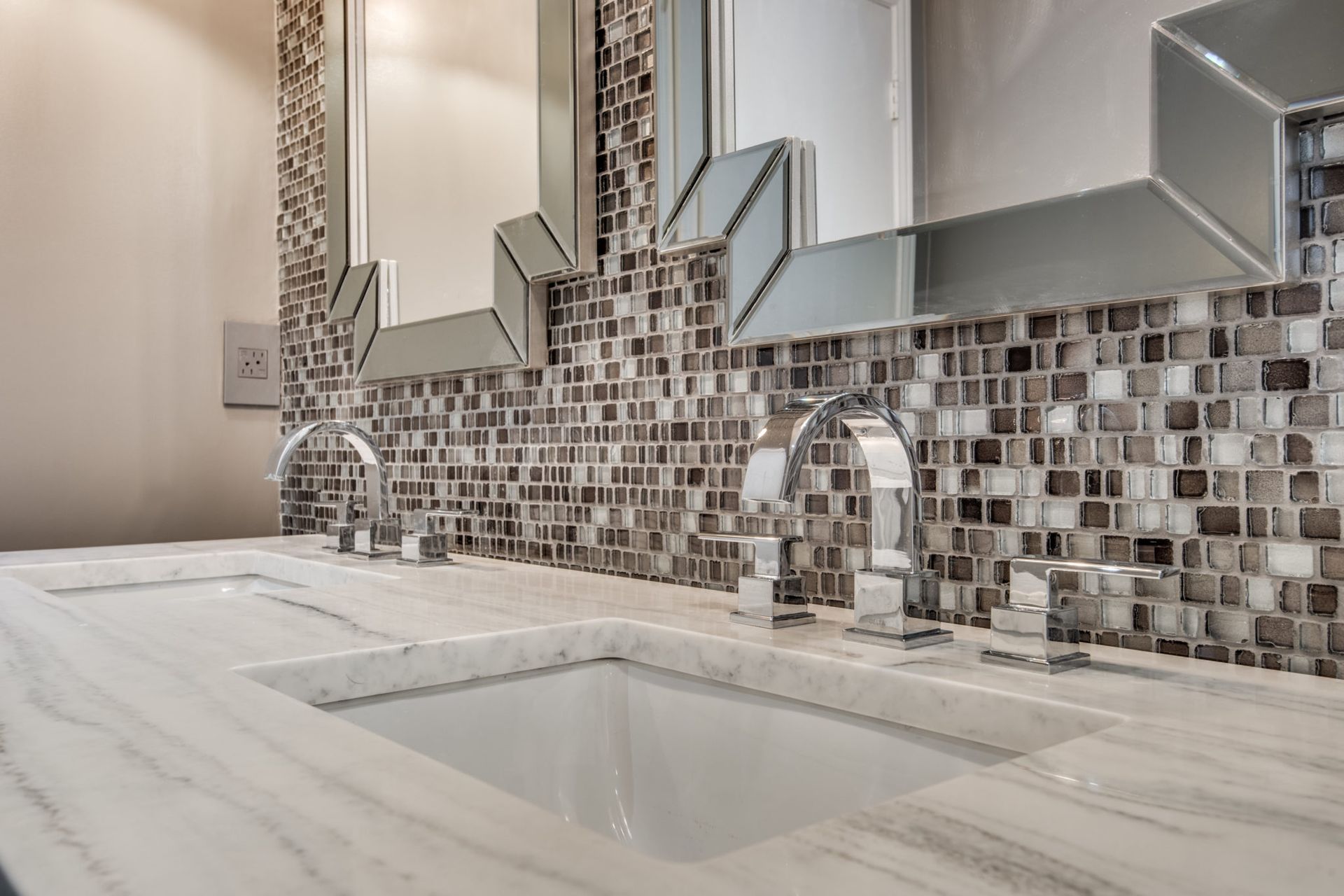 A bathroom with two sinks and two mirrors.