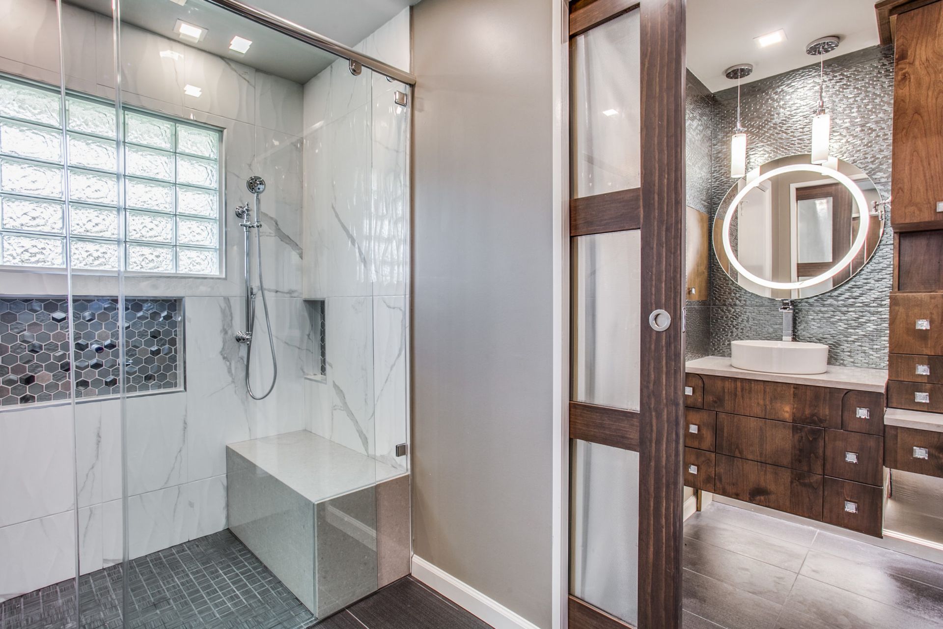 A universal design bathroom with a walk in shower and a sink.