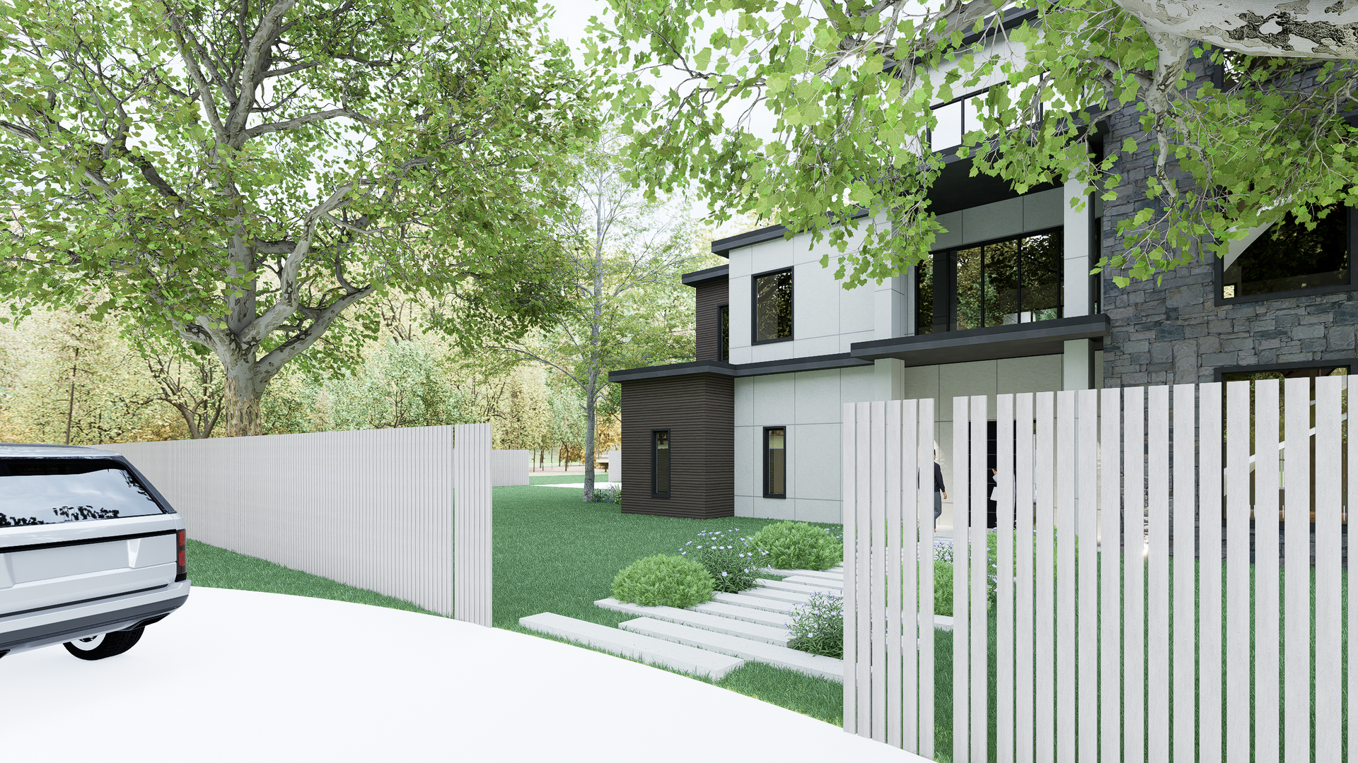 A car is parked in front of a house with a white fence.