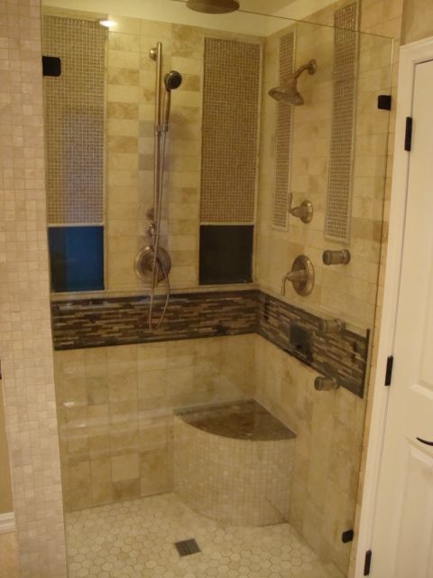 A bathroom with a walk in shower and a bathtub