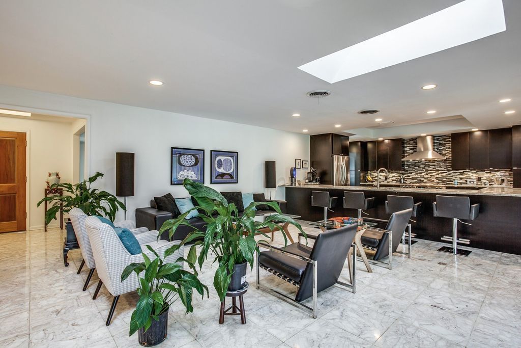 A living room with a lot of furniture and plants