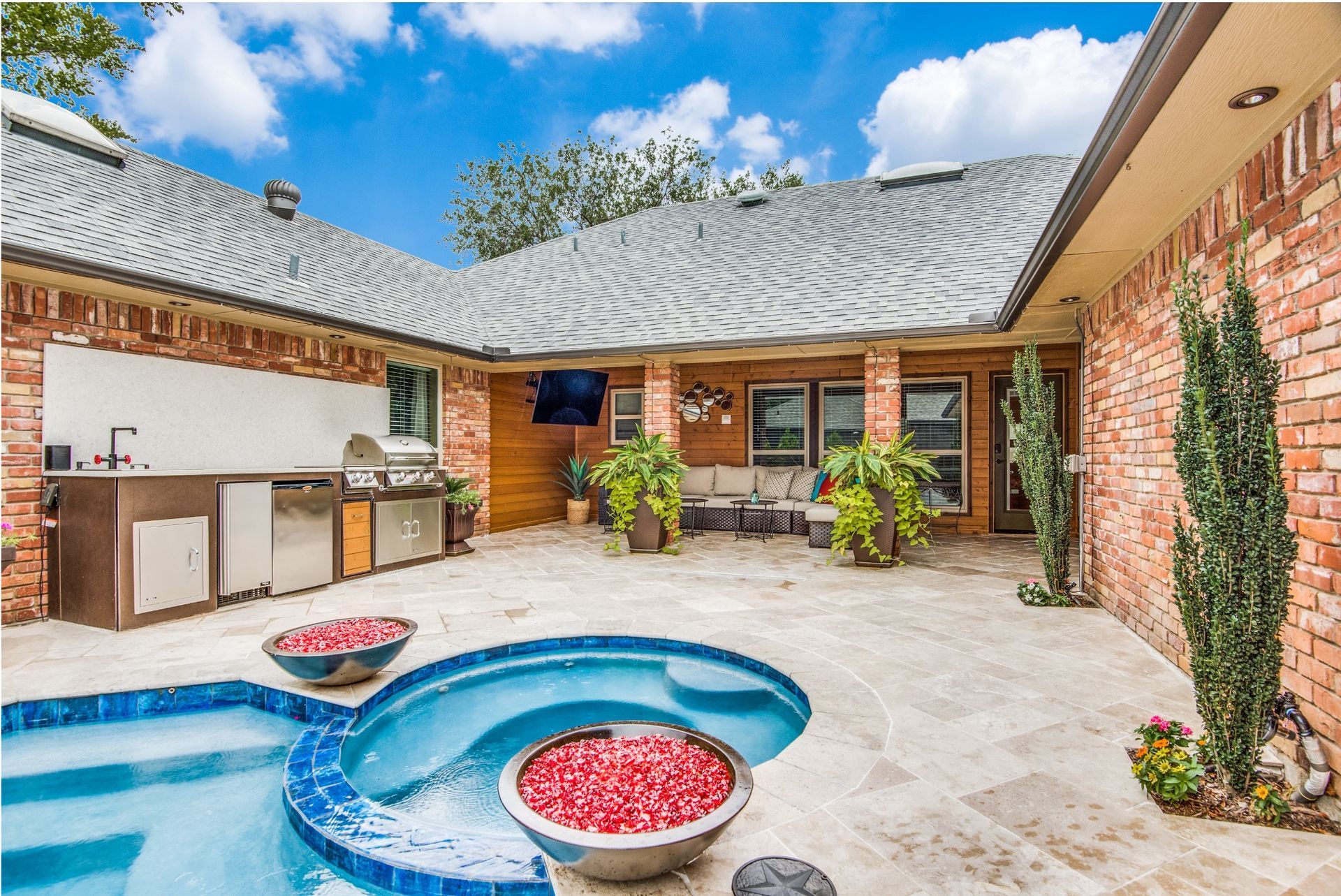 There is a large swimming pool in the backyard of a house.