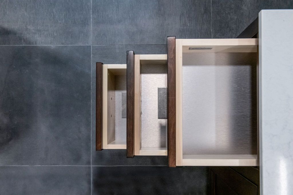 The drawers are open and empty in a bathroom.