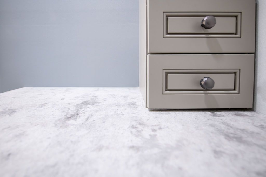 Two drawers are sitting on a marble counter top.